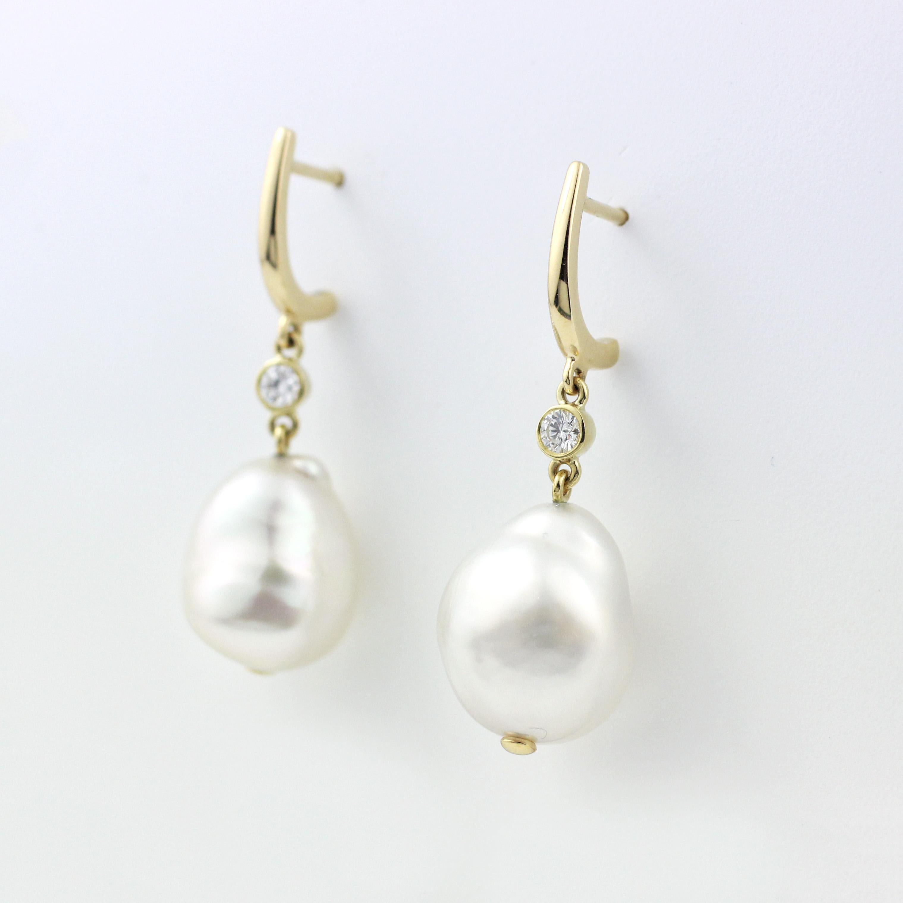 A beautiful pair of 18 Kt Gold, Freshwater Baroque Pearl and Diamond Earrings.  

The large Baroque Pearls in these versatile drop earrings measure 11mm to 12mm.  Two bezel-set Diamonds add a little sparkle ( .10 total carat weight).  18 Kt Gold