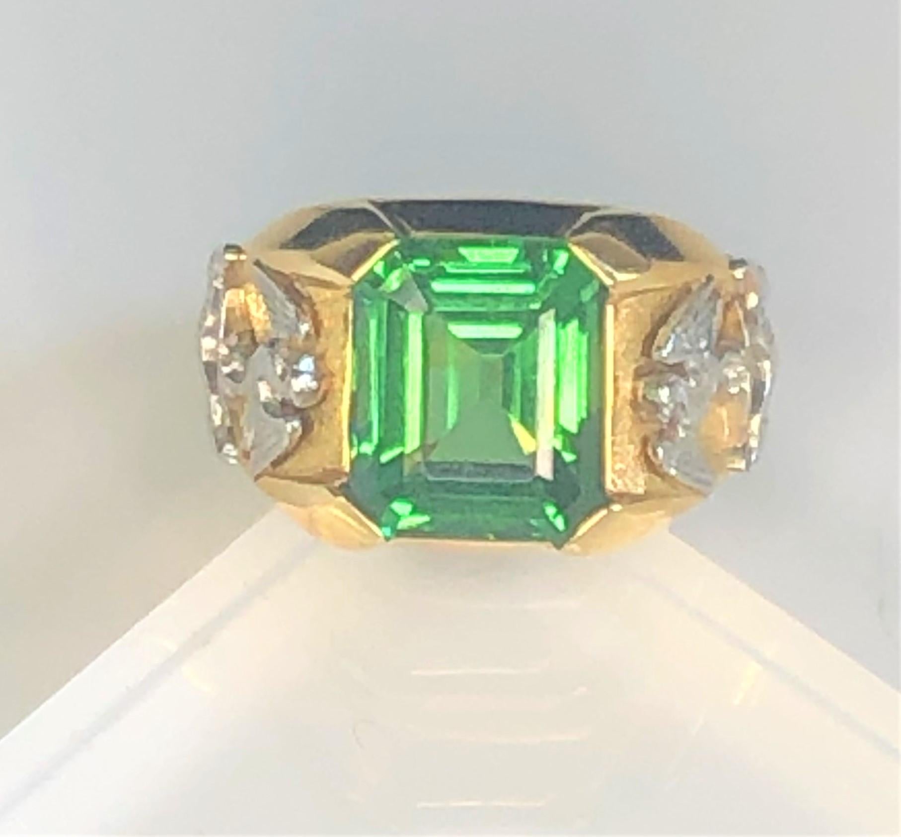 By designer Julius Cohen, this high quality ring is a must have!  Stunning color!
18 karat yellow and white gold mounting
Emerald cut green tsavorite garnet, approximately 6.9 carats approximately 10.6mm x 12.35mm x 5.3mm.
Each shoulder has a white