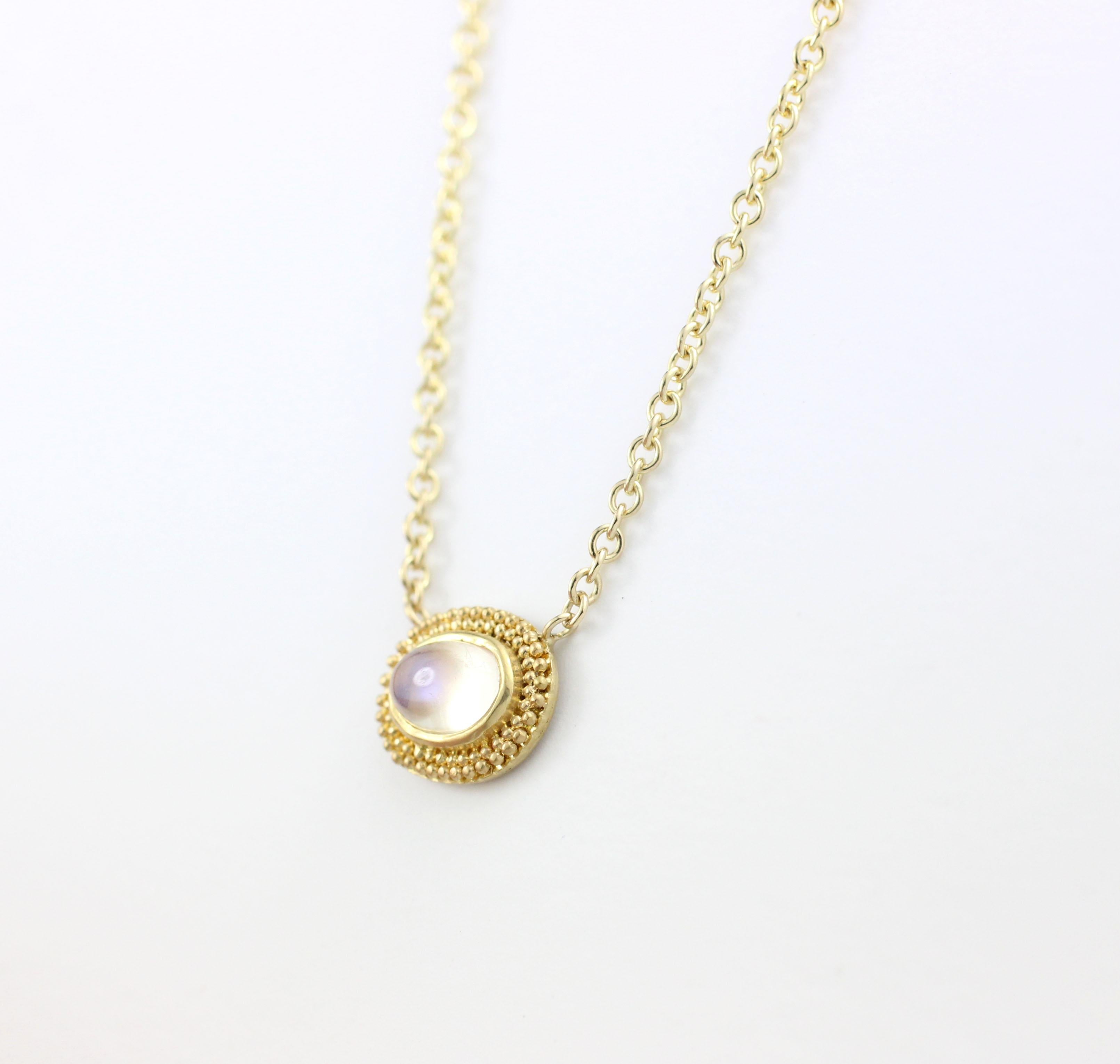 This hand granulated, 22 Kt Gold pendant is stationary on its 17” long, 18 Kt Gold Chain.  It contains One Cabochon Moonstone (.63 Cts.).  One of a Kind.

Designed and Made in-house by Julius Cohen New York.