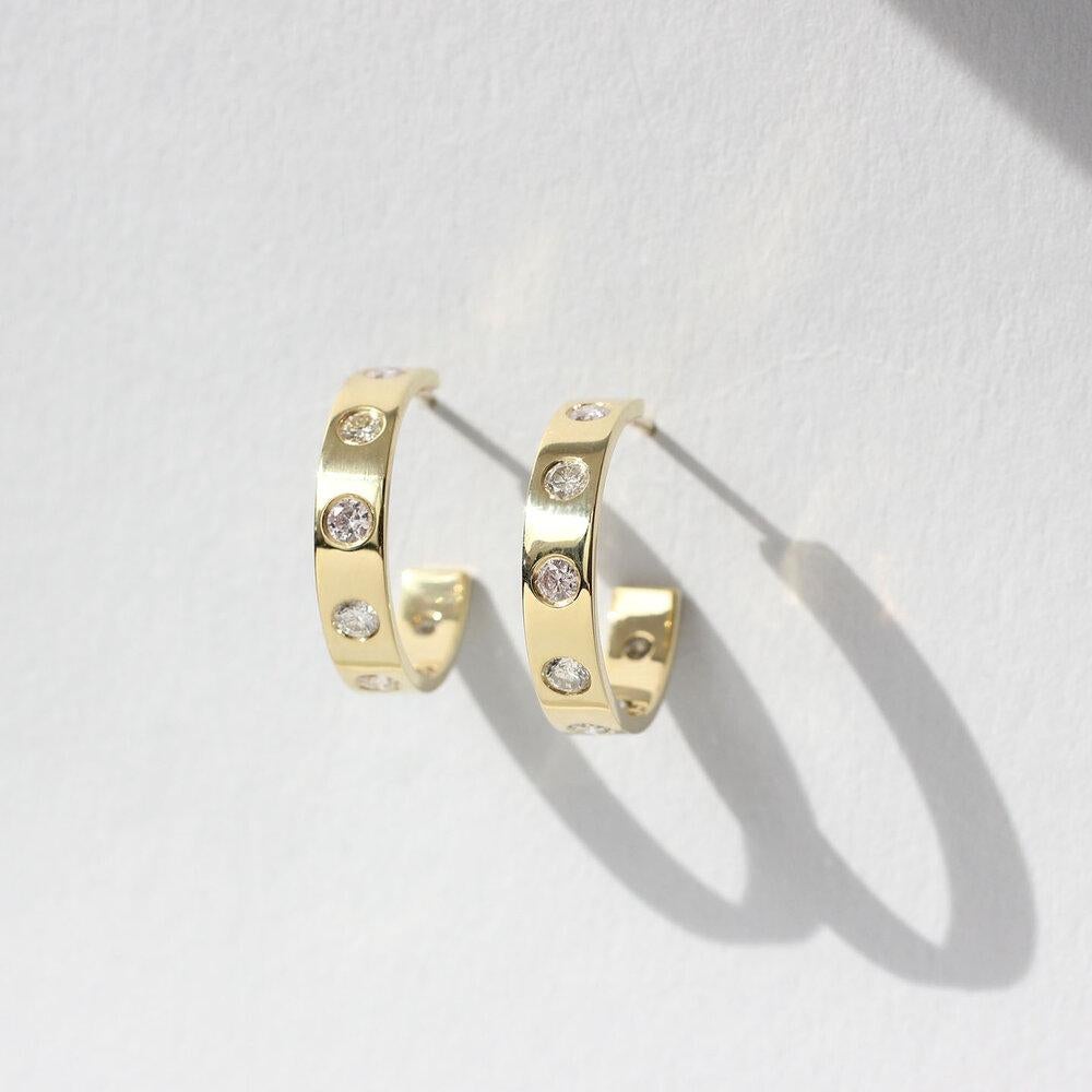 Bauhaus inspired, dress-up or dress-down solid 18 Kt Gold Hoops.  Containing 14 Natural Color Diamonds (.90 Cts.) in a light pastel palette, ranging in subtle color through light pink, gray, and sand tones.   

Designed and made in-house by Julius