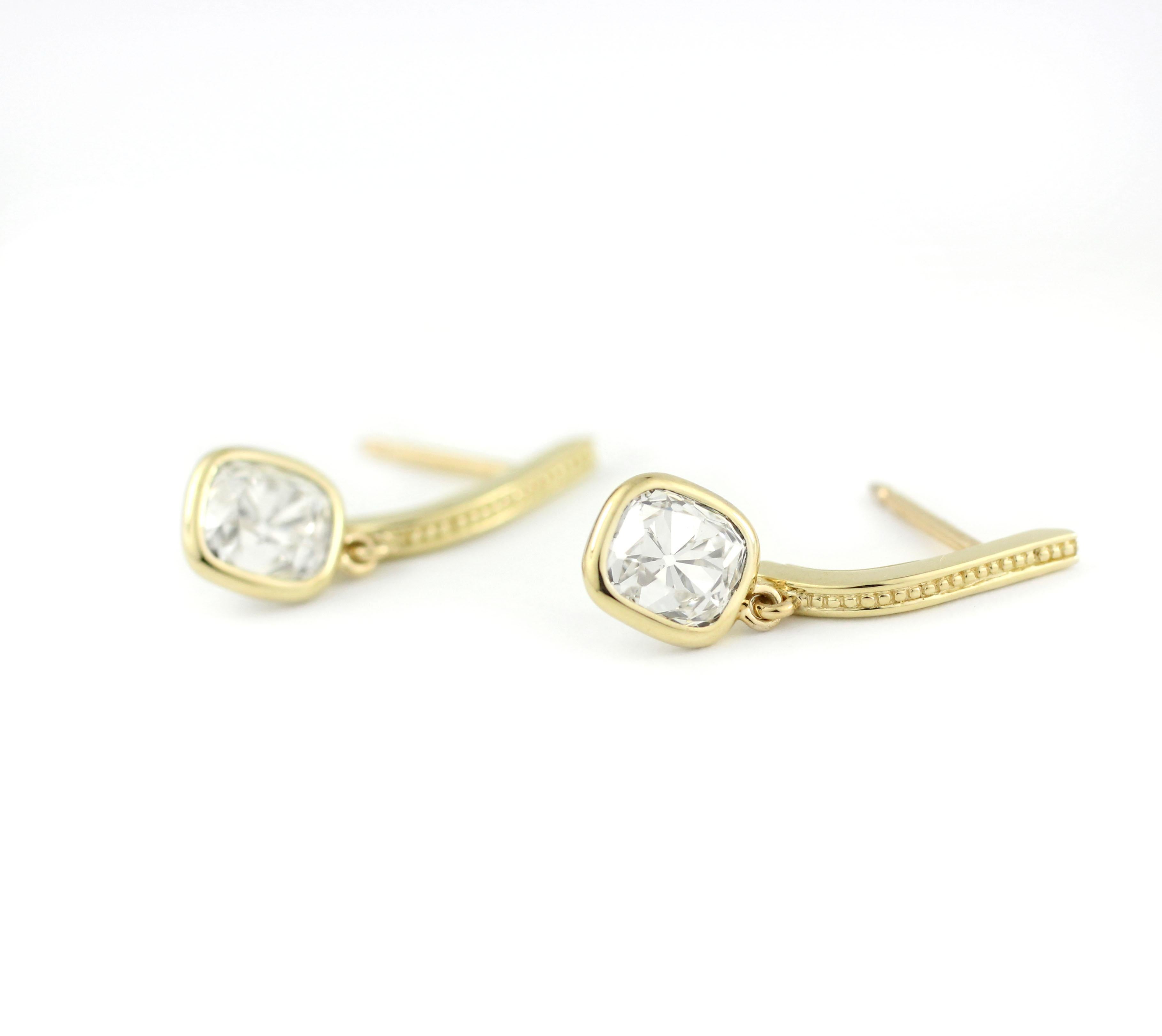 These earrings contain a beautiful vintage pair of Cushion Shape, Old Mine Diamonds, with each stone weighing just over 1.25 Cts.  (2.58 Cts. for the pair, Approx. H-I, VS).  The European cut of these old-miners are warm and charming, possessing a