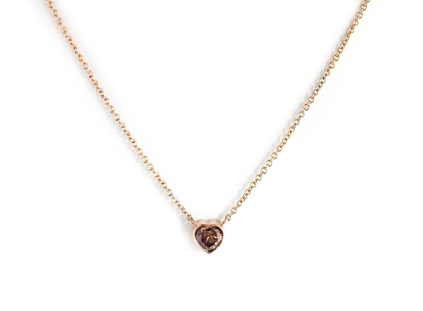 Our 18 Kt Rose Gold and Natural Color Heart Shaped Diamond Necklace.  Simple contemporary bezel-set .95 Ct. stone pendant on a 17