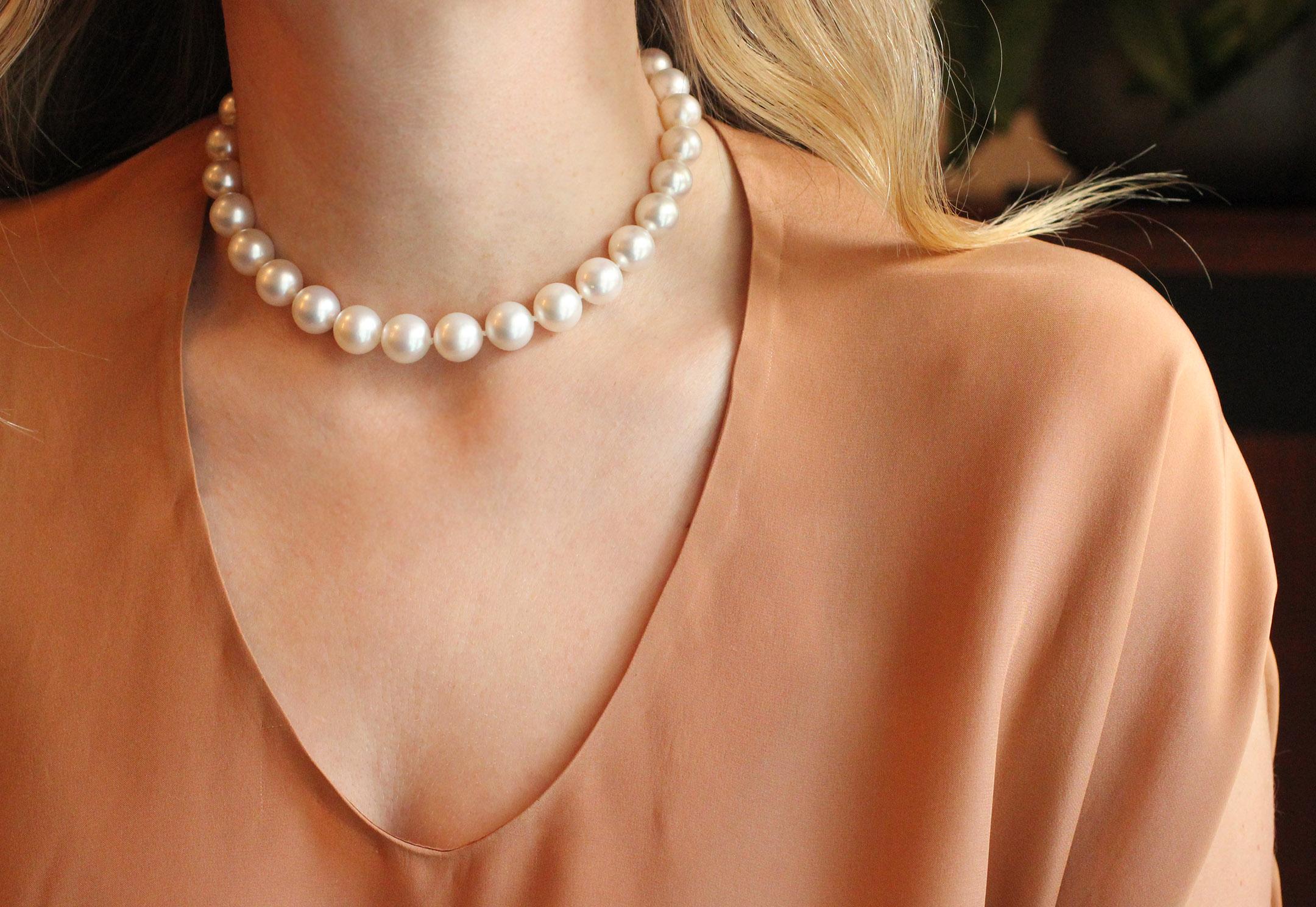 This fine pearl strand choker is gently graduated (pearls 10-12.5mm) and has a beautiful 18 Kt Gold and Diamond ball clasp closure (76 brilliant cut diamonds at 2.90 cts).