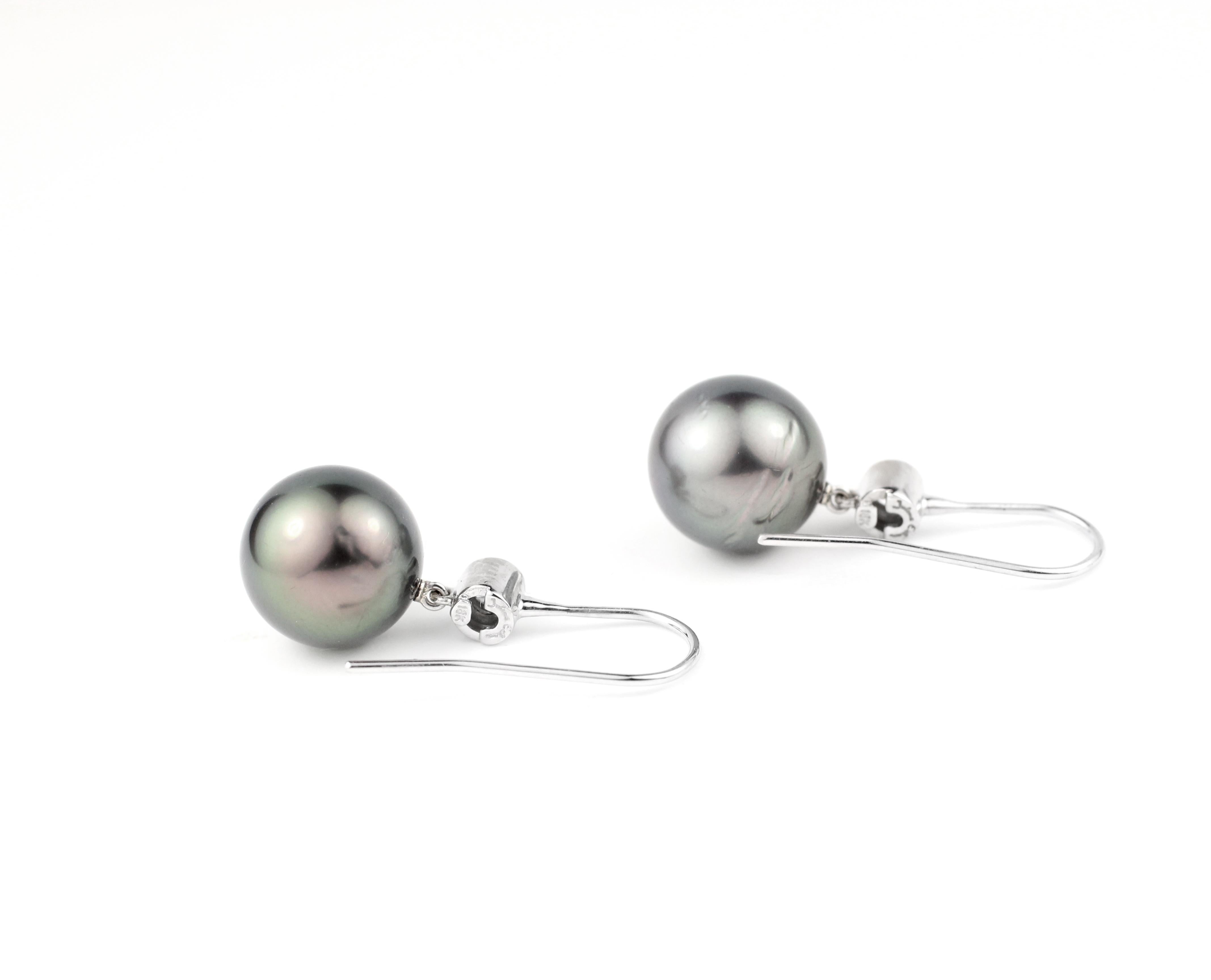 Containing two 11 mm fine Tahitian Pearls in 18 Kt White Gold hanger-style hook settings with two Brilliant Diamonds (.19 Cts.), just for a little sparkle.

Designed and made in-house by Julius Cohen New York.  