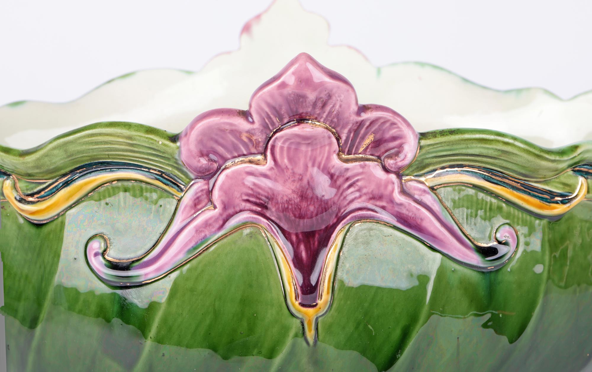 A finely potted Austrian Art Nouveau Majolica centrepiece or jardinière by the renowned manufactory of Julius Dressler and dating from around 1900. This stunning an elegant piece stands raised on a leaf shaped pedestal foot the ribbed bowl-shaped
