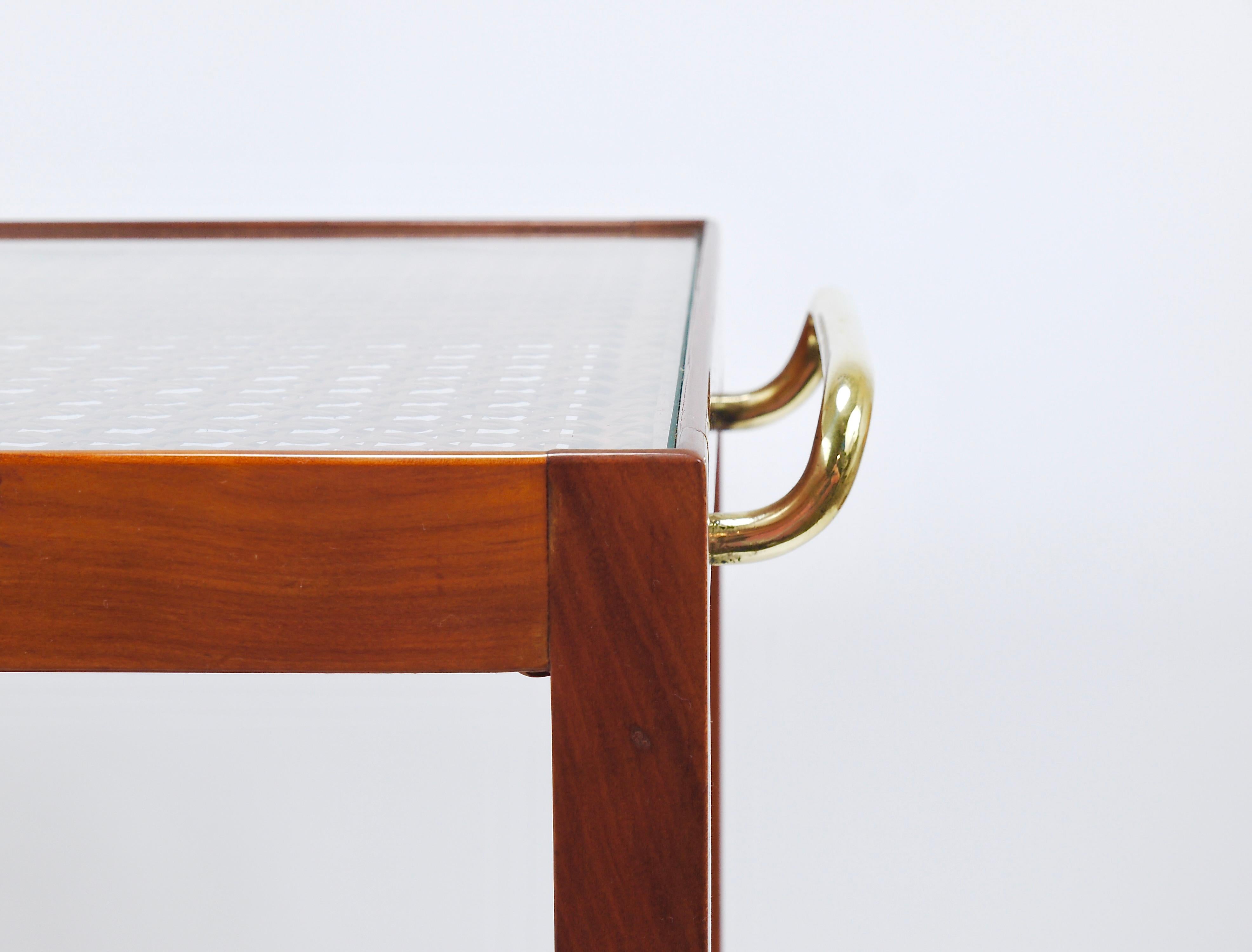 An elegant, sleek minimalist two-tiered bar cart or serving table from the 1930s, designed by Julius Jirasek and crafted by Werkstätte Karl Hagenauer, Vienna, Austria. This piece exemplifies refined craftsmanship, made of solid cherry wood and