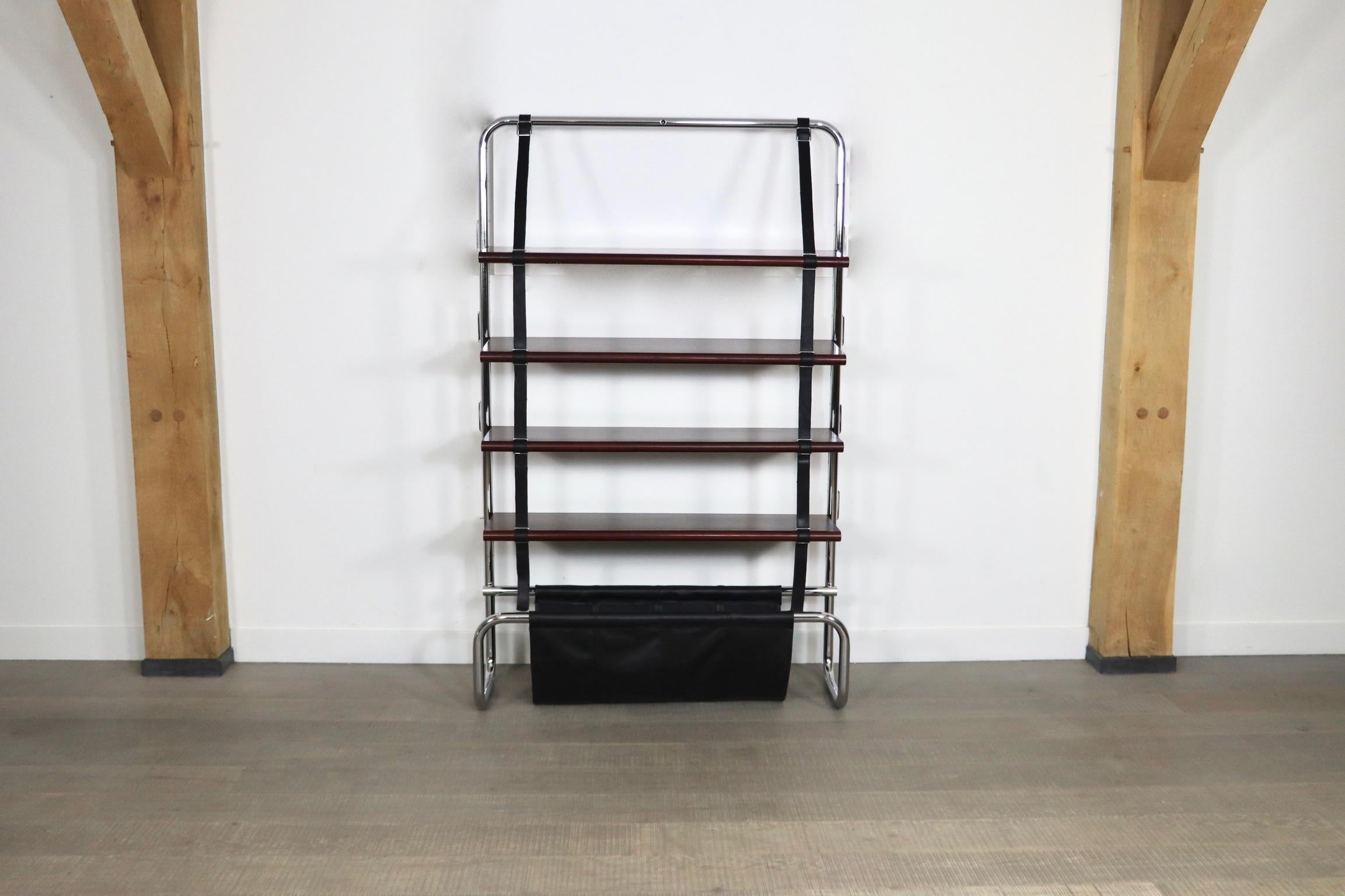 Beautiful Jumbo wall unit designed by Luigi Massoni for Poltrona Frau, Italy 1971. Chromed tubular steel frame with cherry wood shelves suspended by black leather straps. At the base there is a black saddle leather pouch - perfect for holding