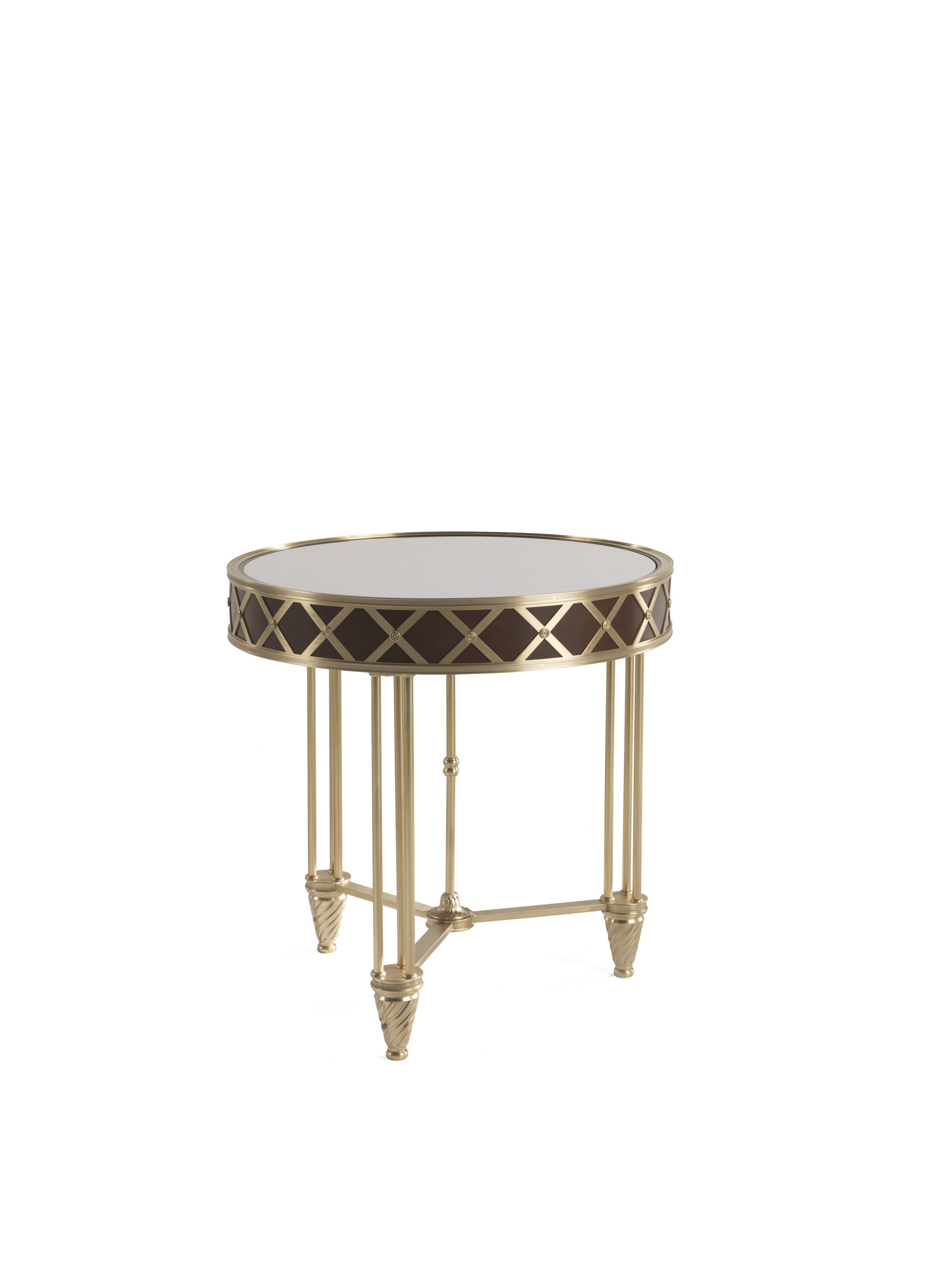 A revisited Art Deco style for Cassis side table. An elegant piece of furniture with a bold character, perfect to be inserted in settings of different styles. The table features a structure in lost-wax cast brass and top in walnut and marble.
Cassis