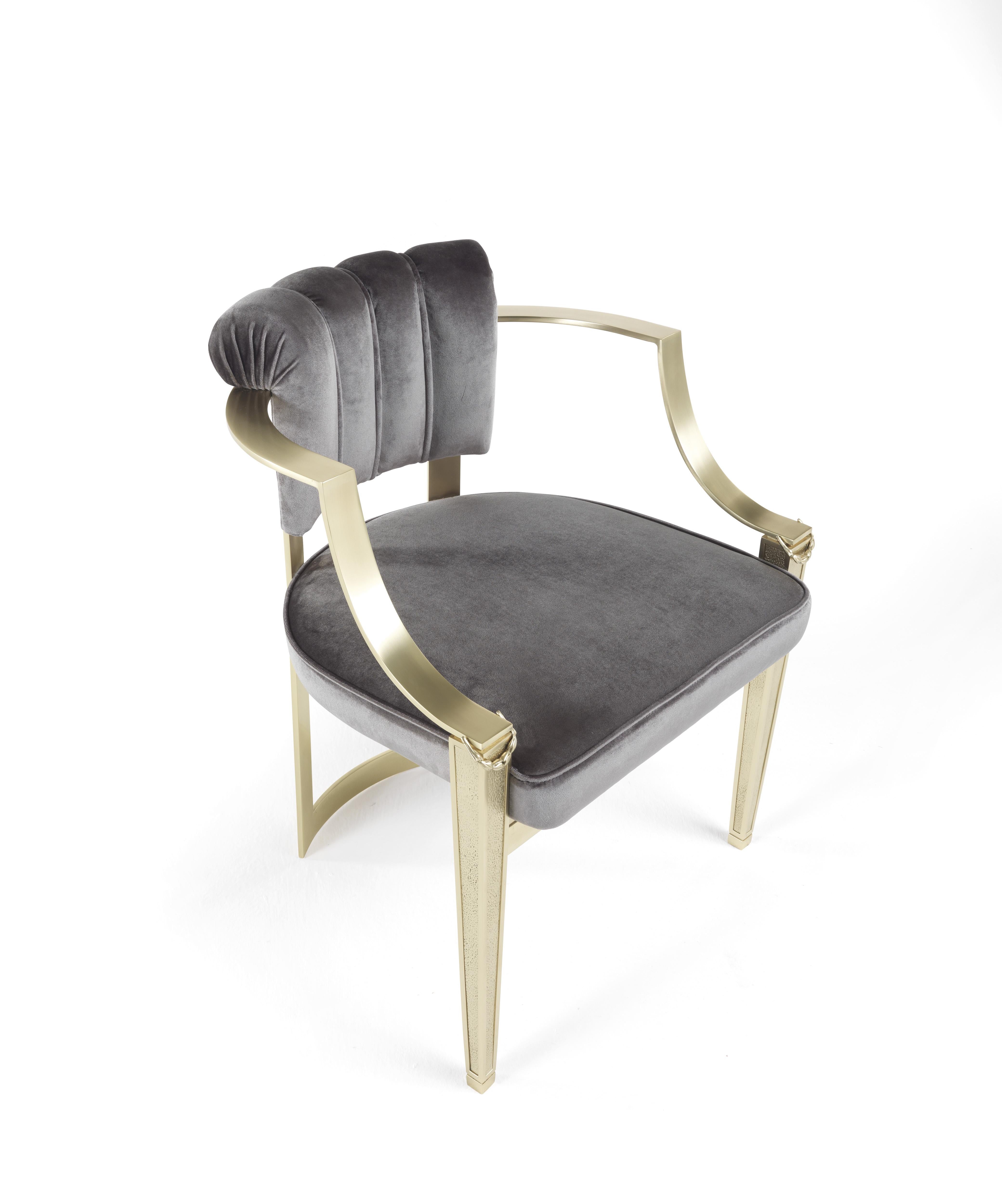 Halfway between chair and armchair, Fuji is a refined piece of furniture expressing a fresh and light-filled classic style. It features a shell-shaped backrest covered in silk satin of the collection and antiqued gold finished legs.
Fuji chair with