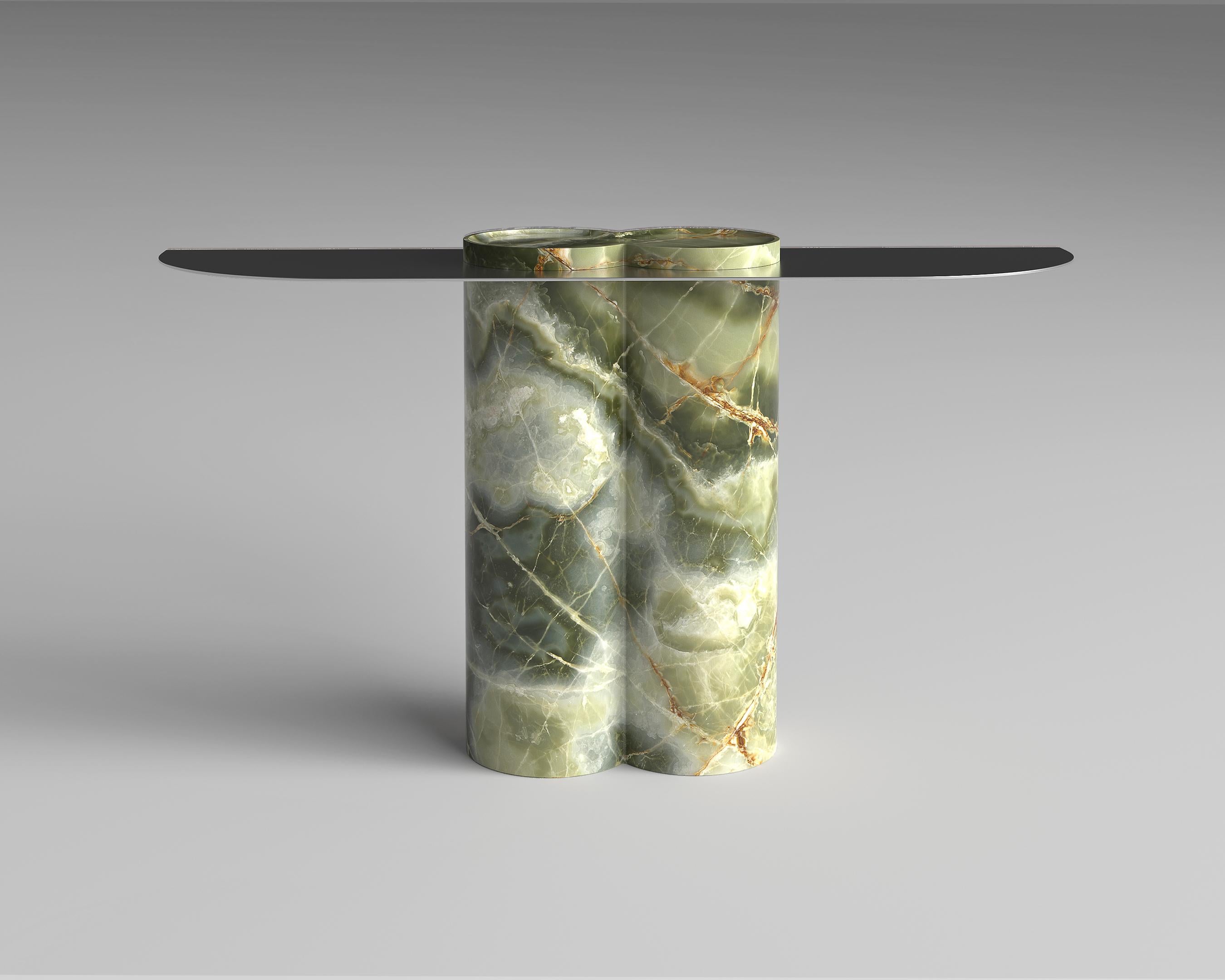 Carved form a monolithic piece of marble, the base of jumbo Console supports a finely fabricated metal top that gives an airy elegance to the whole composition. Available in different stones and metal finishes, Jumbo Console 100% crafted in Italy on