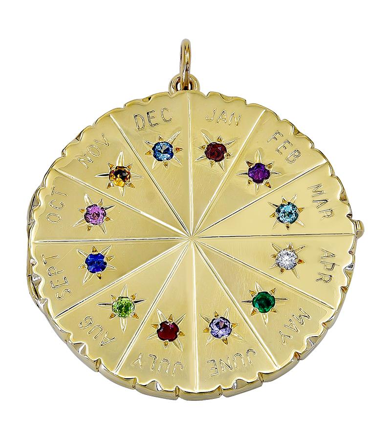 Best ever calendar locket:  Jumbo size, with names of months engraved.  Each month is set with its bright faceted birth stone, within a rayed star.  Very solid 14K yellow gold.   Opens to reveal a bezel to hold a photograph.  Diameter is over 1