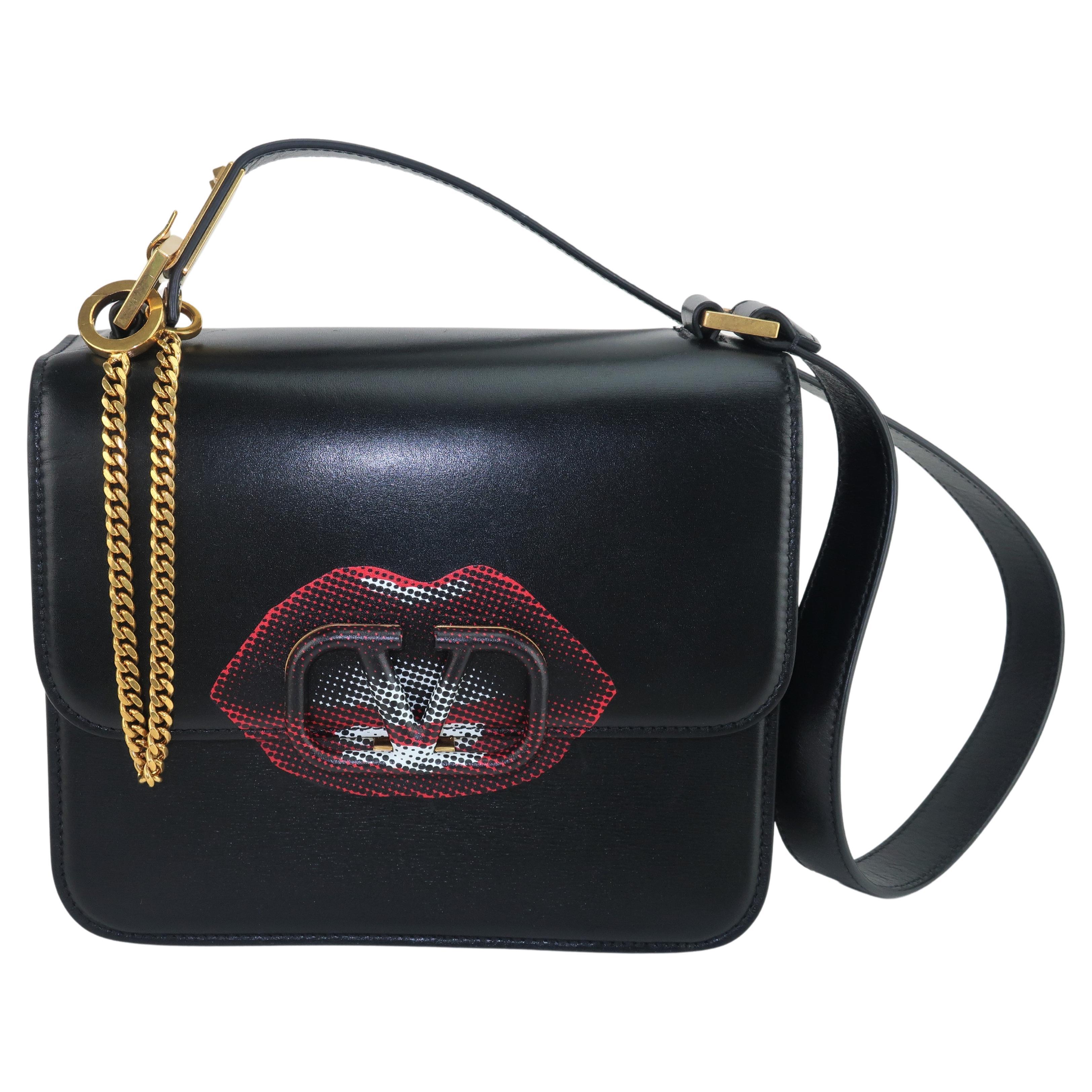 Fall 2019 V-Sling black leather handbag from the creative collaboration of Jun Takahashi, famed Japanese streetwear designer, and Valentino ... a design house synonymous with Italian luxury.  This fabulous and functional bag is a wonderful