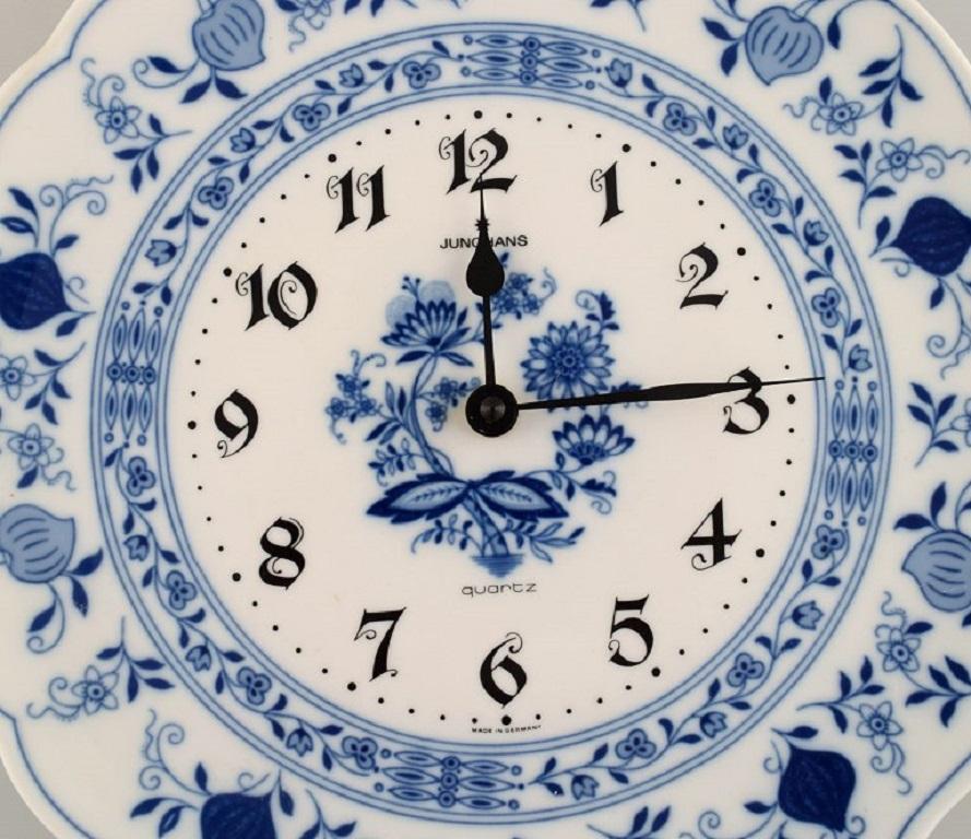 Junghans porcelain wall clock. 
Meissen Blue Onion style. Germany, 1970s.
Diameter: 29 cm.
Depth: 4.5 cm.
In excellent condition.
Stamped.