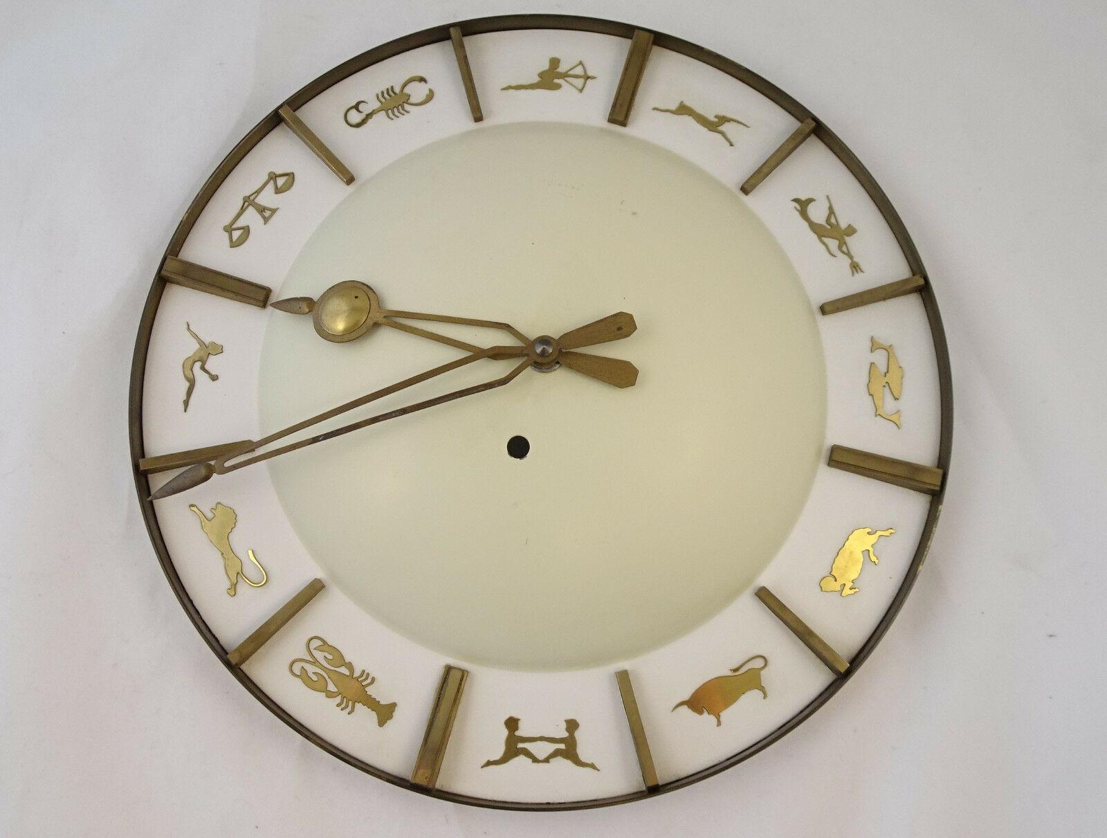 Junghans brass wall clock with zodiac signs.
Fitted with quartz movement working with a standard AAA battery.