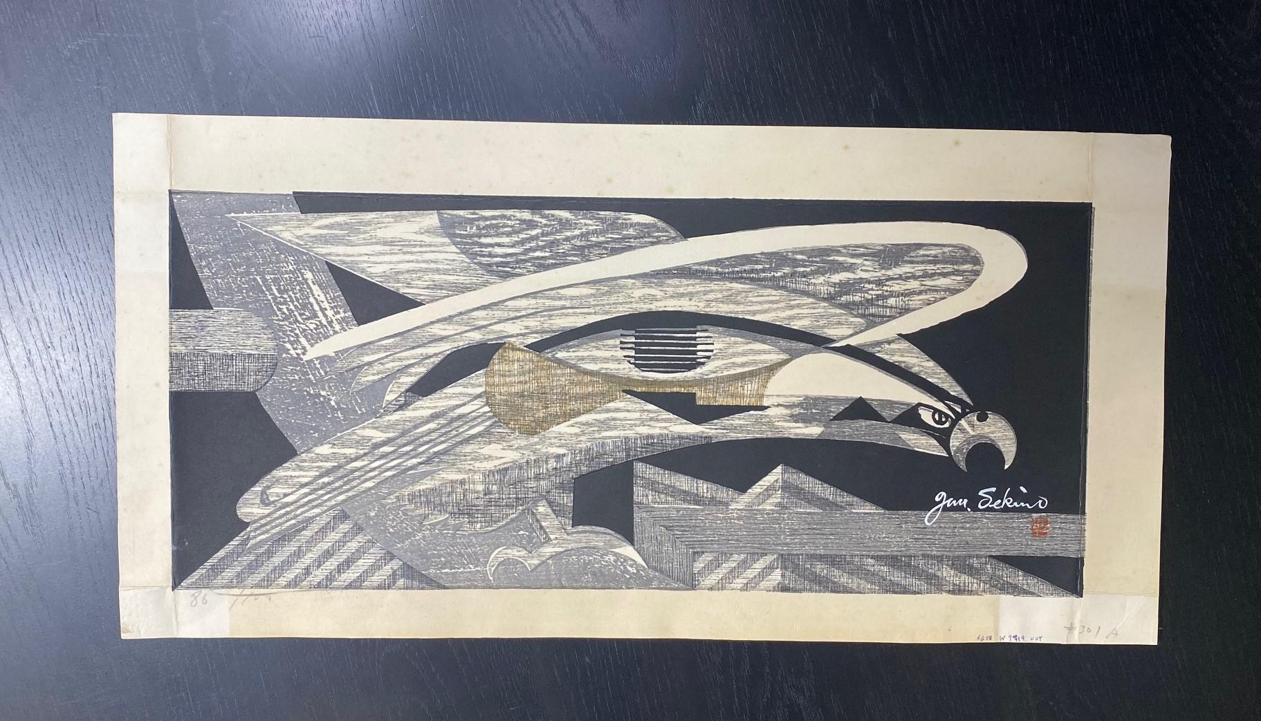 A bold abstract limited edition woodblock print by famed Japanese artist/printmaker Junichiro Sekino featuring a fierce bird likely an eagle or hawk.  The wood grain of the printing blocks is quite wonderful in this work.  

The print is signed in