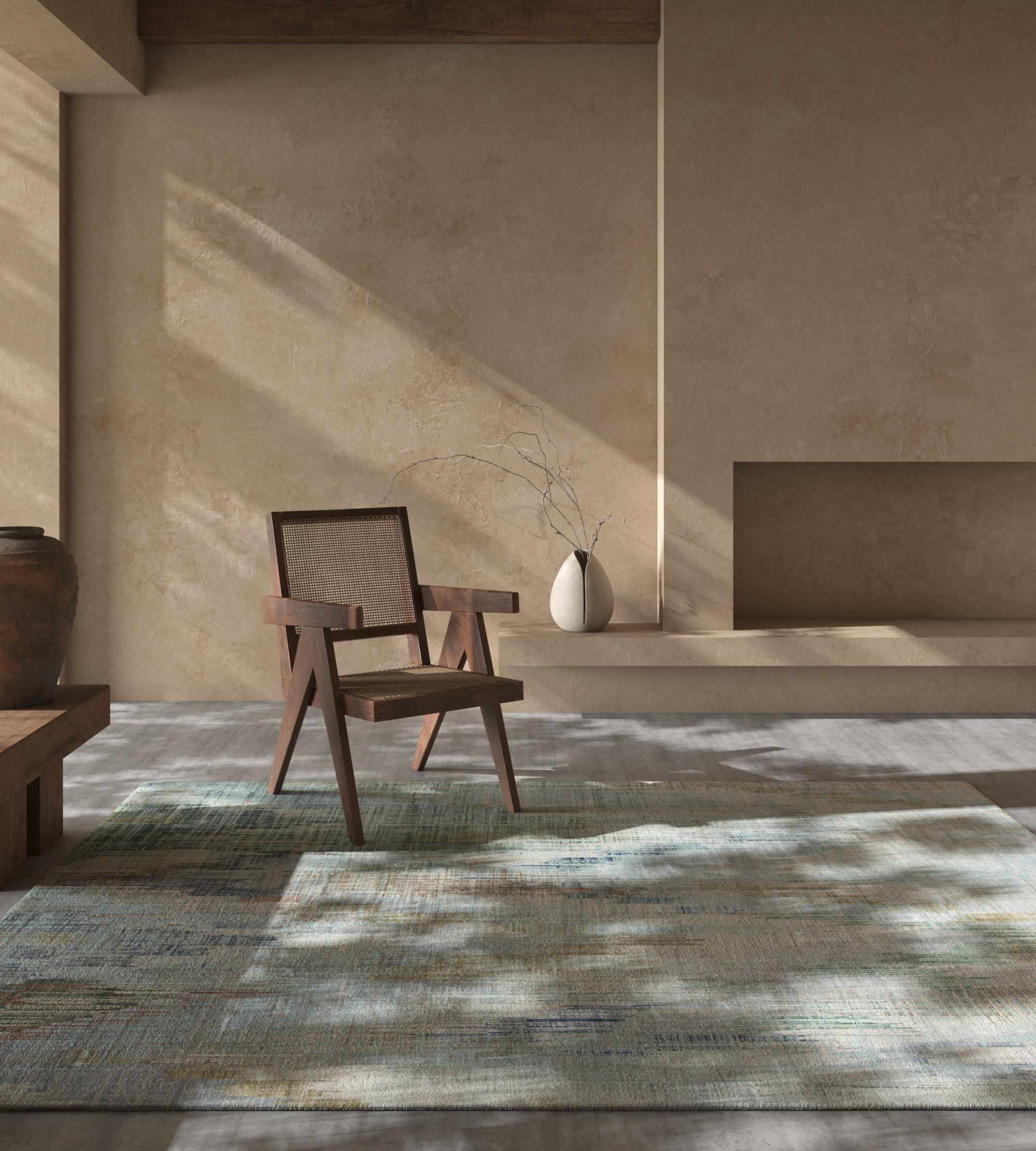 This hand knotted rug from our Unstring By Kavi collection is a testament to exquisite craftsmanship and timeless design. Featuring a captivating pattern in shades of sea mist green and ivory, forming an intricate blend of speed waves that adds a