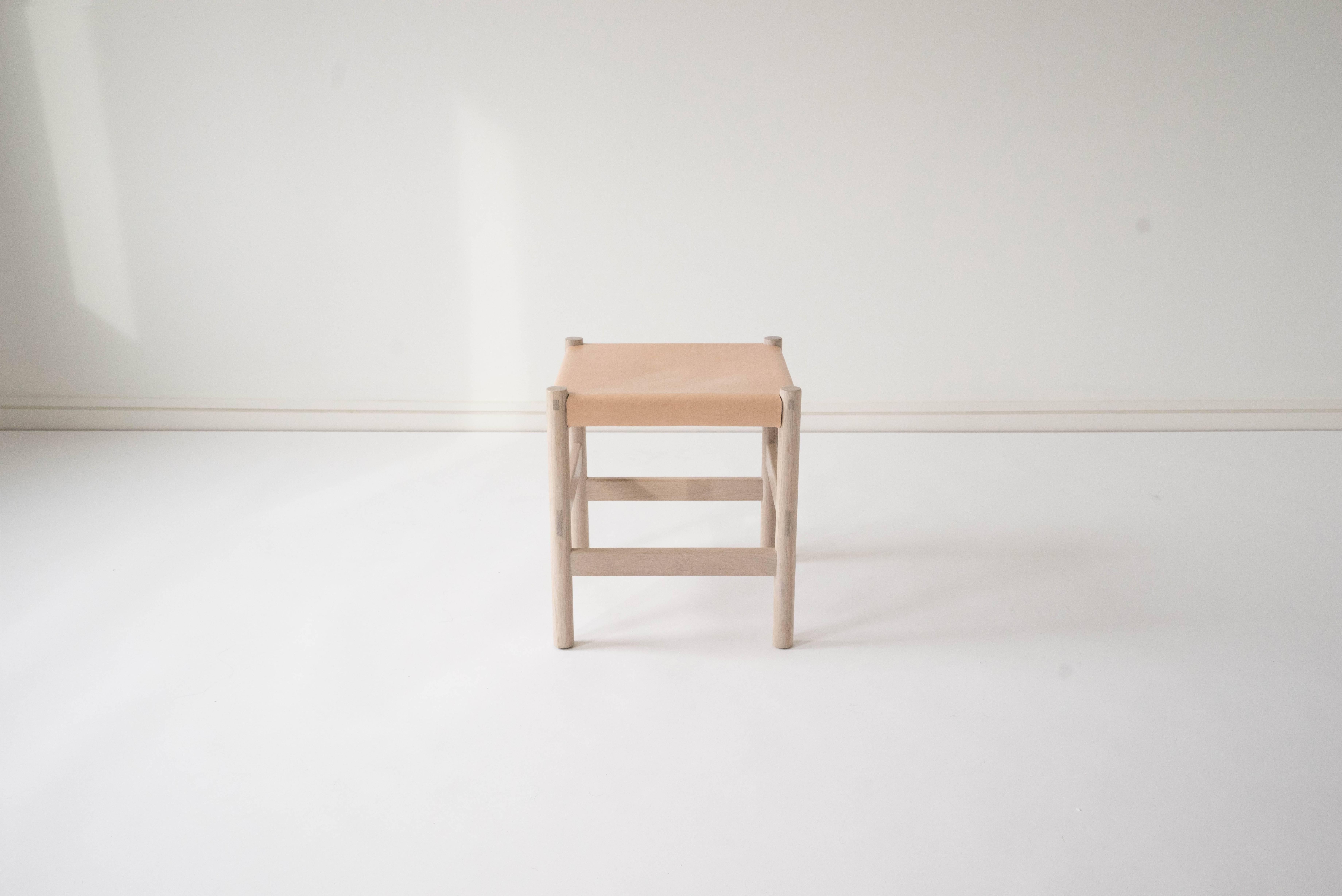 Sun at Six is a Brooklyn design studio. We work with traditional Chinese joinery masters to handcraft our pieces using traditional joinery. Handcrafted using traditional joinery. A simple, versatile stool. The vegetable tanned leather will patina
