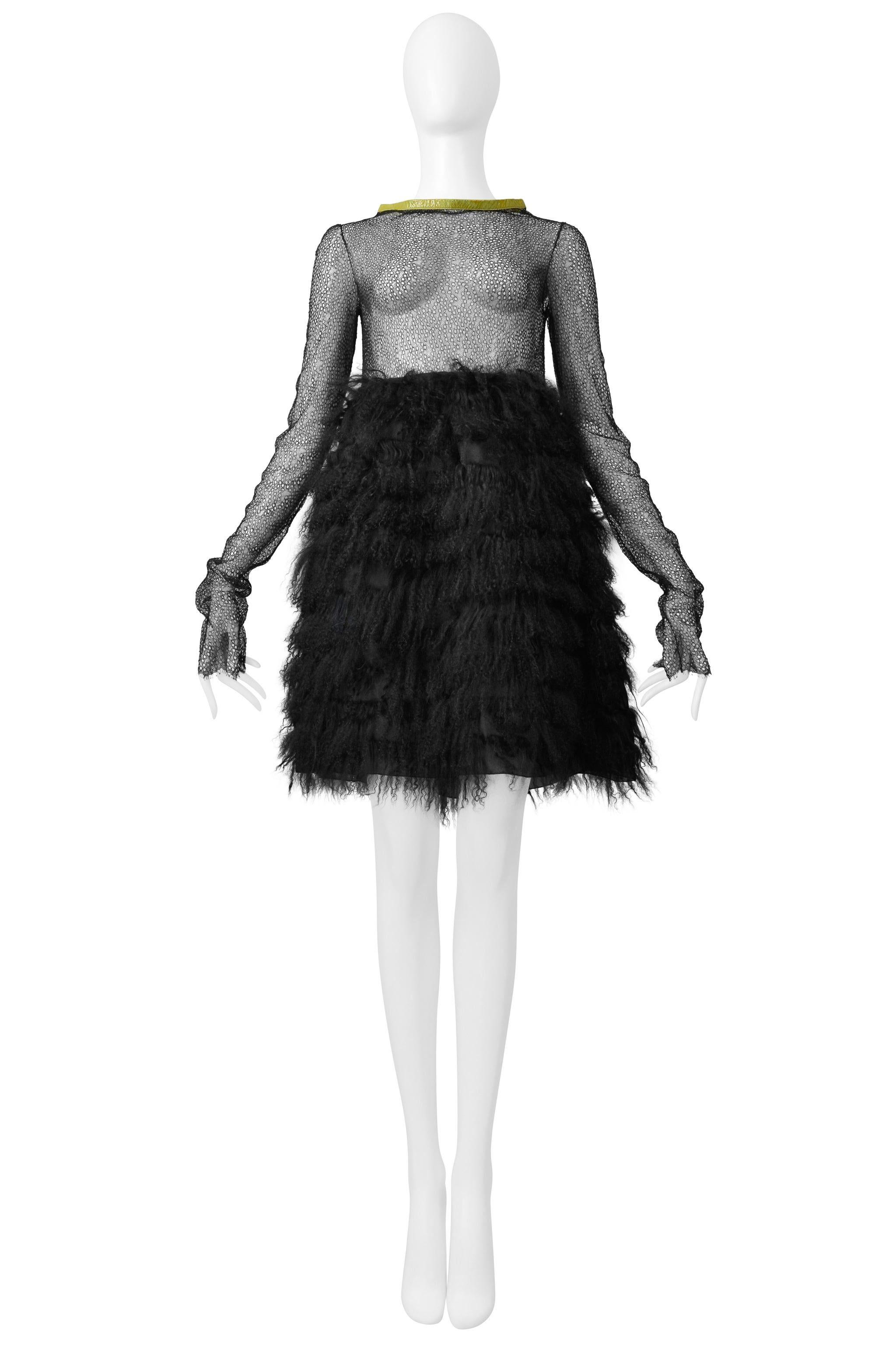 Resurrection Vintage is excited to offer a vintage Junko Shimada black cocktail dress featuring a black lace bodice, an organza skirt with black curly shearling panels, a patent leather yellow trim neckline, and above-the-knee length. 

Junko