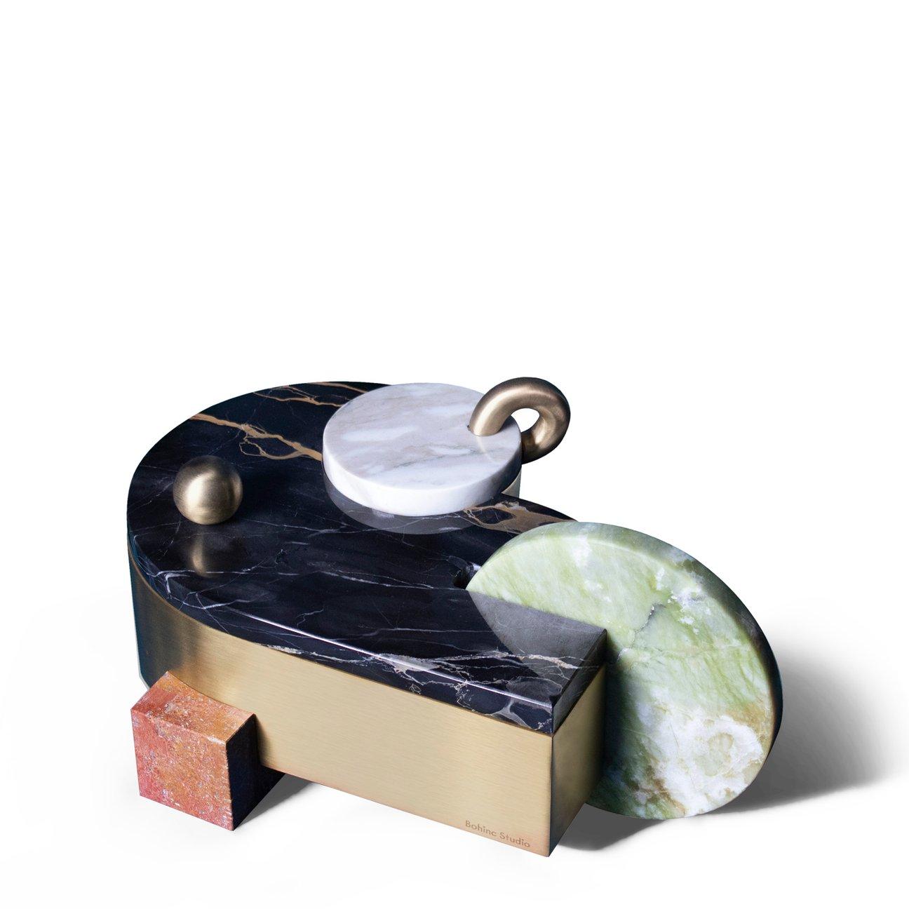 Bohinc Studio’s new Juno box comprises a large brass body and a smaller round compartment. Details in green ming, red travertine, calcatta and portoro marbles add a playful, almost feminine, touch to the otherwise predominantly geometric
