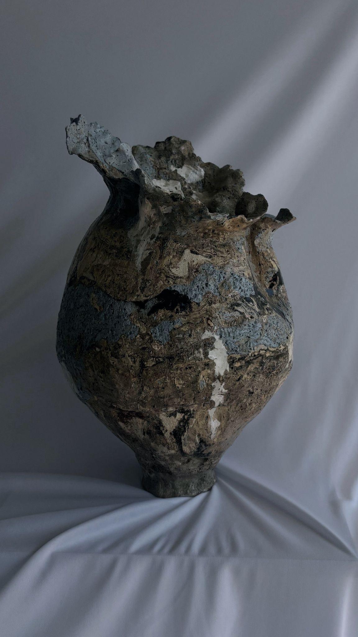 The second stands tall, her broad shoulders and crown-like opening evoking a powerful presence. She is Juno—queen of the gods, embodiment of feminine strength and resilience. Cracked yet proud, she wears her fractures like armor, each line telling a