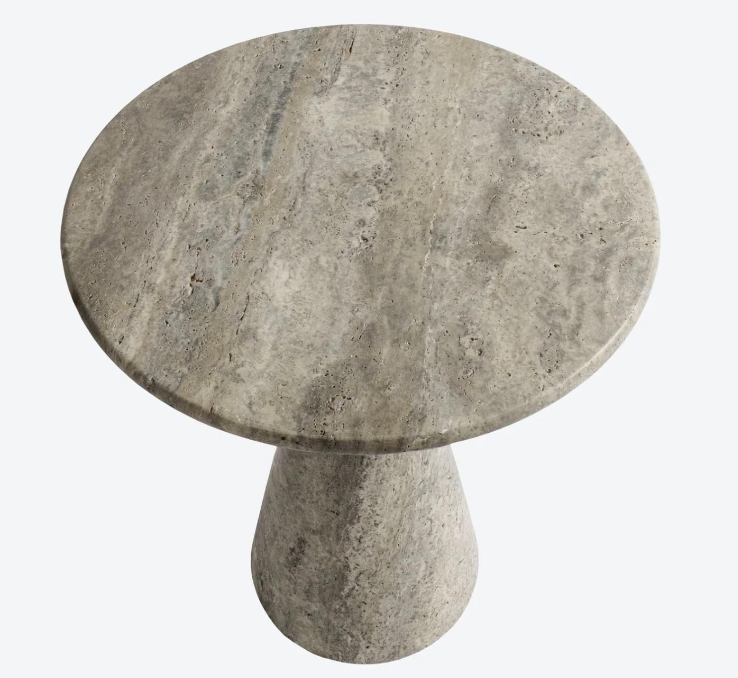 Our most versatile side table made of silver travertine. A simple elegant shape carved from a solid block of stone. This occasional stone table can be used virtually anywhere - next to a sofa, chair, bed, or bath. Sold individually, but can easily