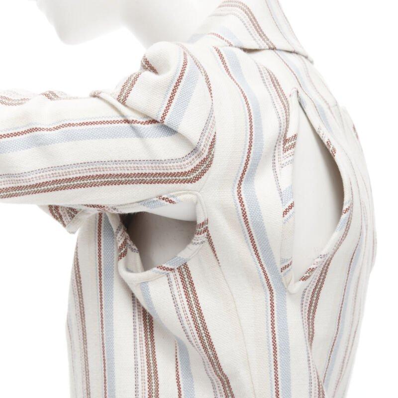 JUNYA WATANABE 1995 beige stripe cotton cut out sleeve double breasted jacket S
Reference: CRTI/A00316
Brand: Junya Watanabe
Designer: Junya Watanabe
Collection: 1995
Material: Cotton
Color: Beige, Red
Pattern: Striped
Closure: Button
Made in: