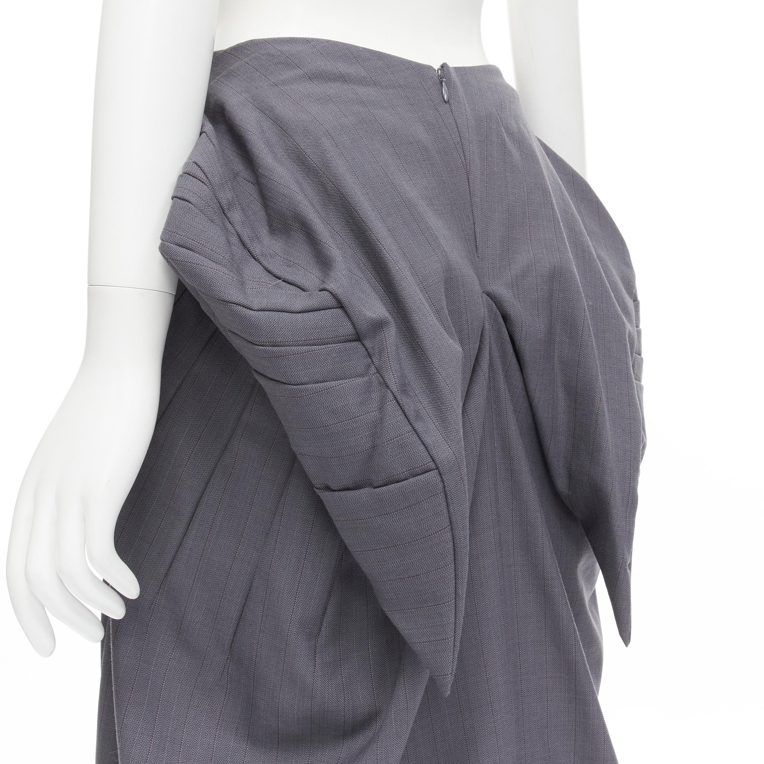 JUNYA WATANABE 1996 grey pleated tie bustle contrast hem midi skirt S 
Reference: CRTI/A00490 
Brand: Junya Watanabe 
Collection: 1996 
Material: Cotton 
Color: Grey 
Pattern: Pinstri 
Closure: Tie 
Extra Detail: Panelled waist. Self tie at back.