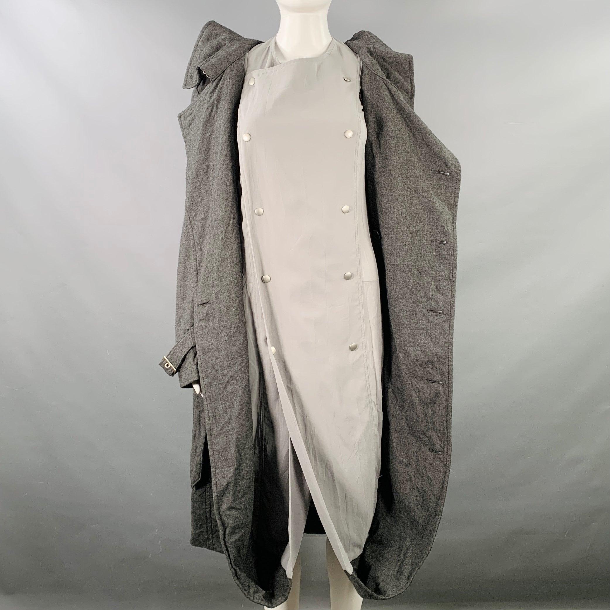Vintage 2007 JUNYA WATANABE trenchcoat
in a grey wool with light grey attached double breasted lining featuring a double breasted style, bubble hem, and single button closure with belt.Excellent Pre-Owned Condition. 

Marked:   M, fits like S