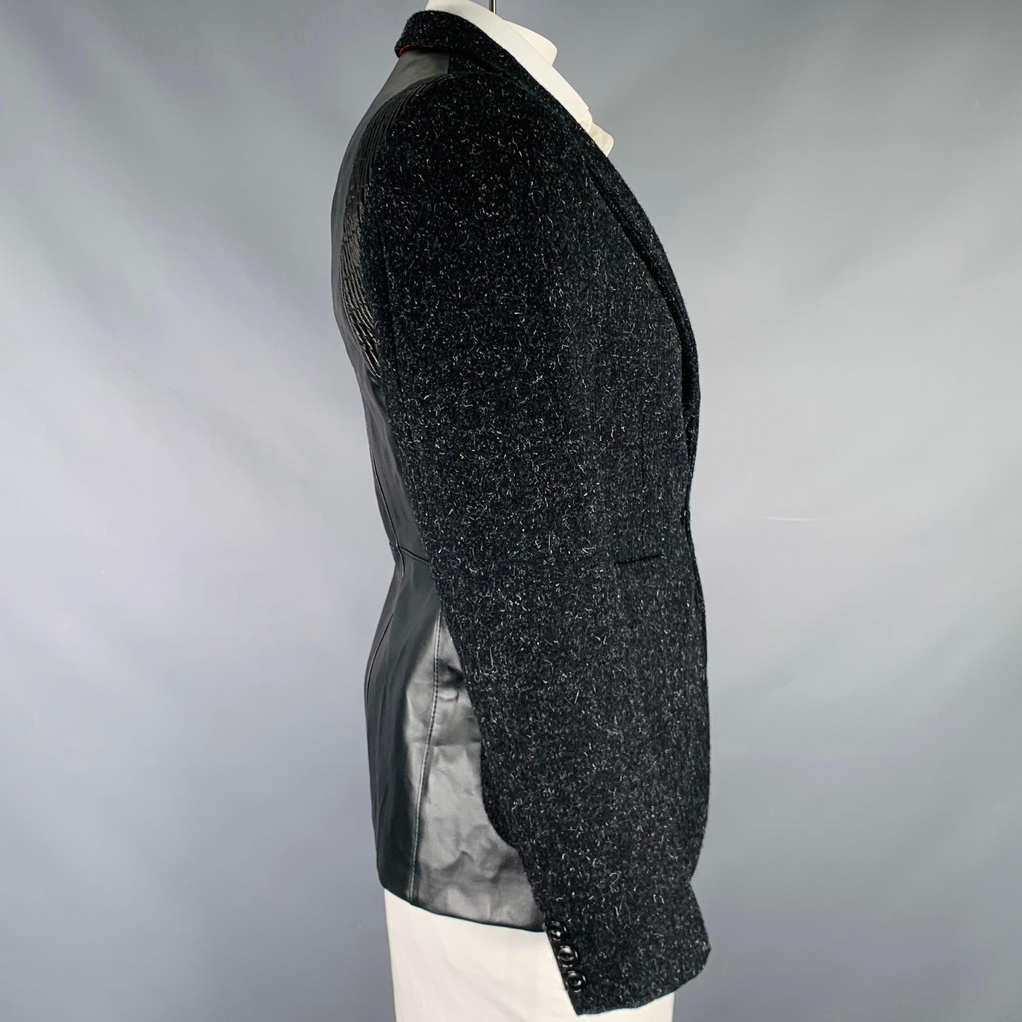 JUNYA WATANABE 2010 sport coat
in a grey and black wool fabric featuring a synthetic leather back, notch lapel, ventless back, and single button closure. Made in Japan.Excellent Pre-Owned Condition. 

Marked:   L 

Measurements: 
 
Shoulder: 18