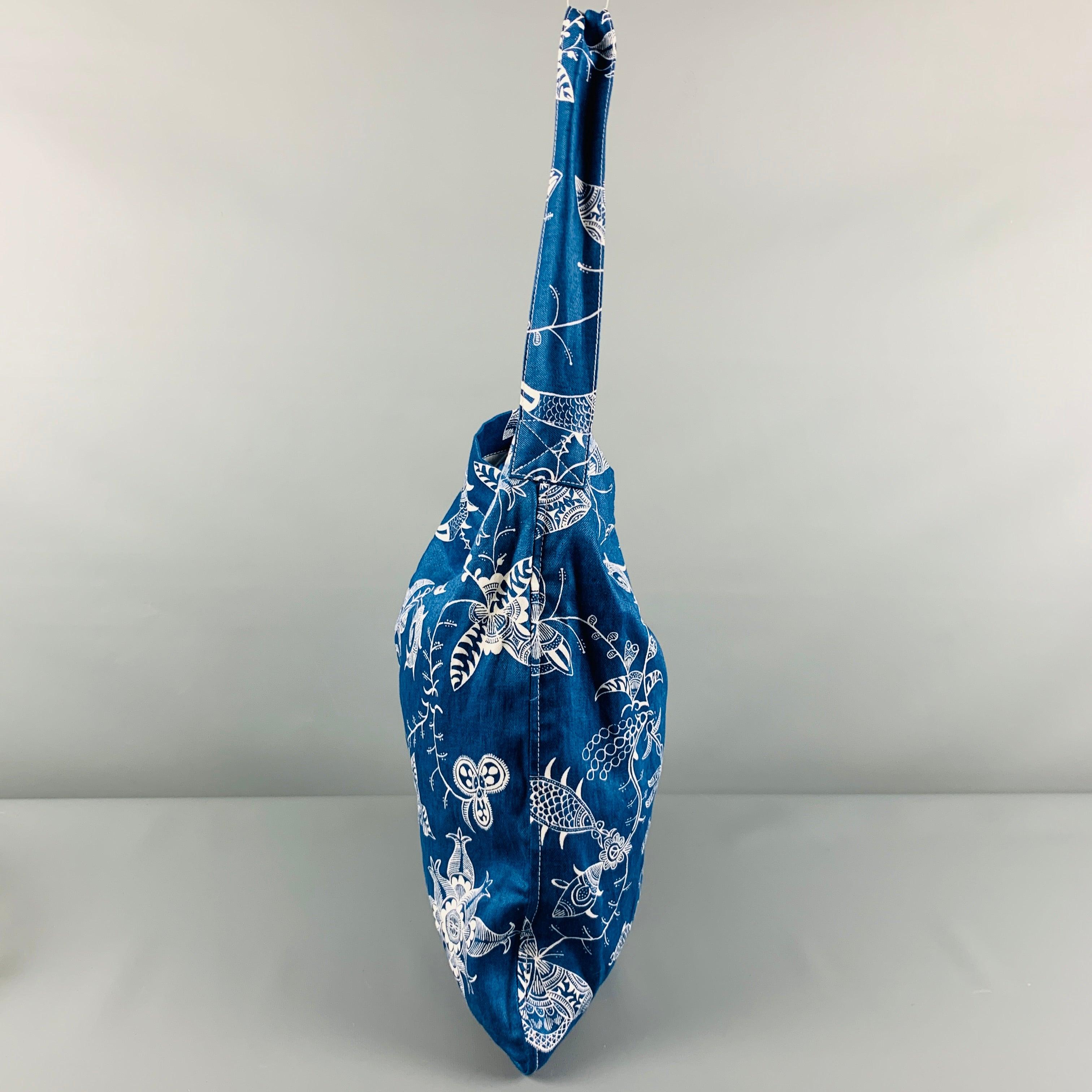 JUNYA WATANABE tote
in a blue and white linen fabric featuring abstract floral pattern, and snap closure.Very Good Pre-Owned Condition. Minor signs of wear. 

Measurements: 
  Length: 14 inches Height: 16 inches Drop: 10.5 inches 
  
  
 
Reference