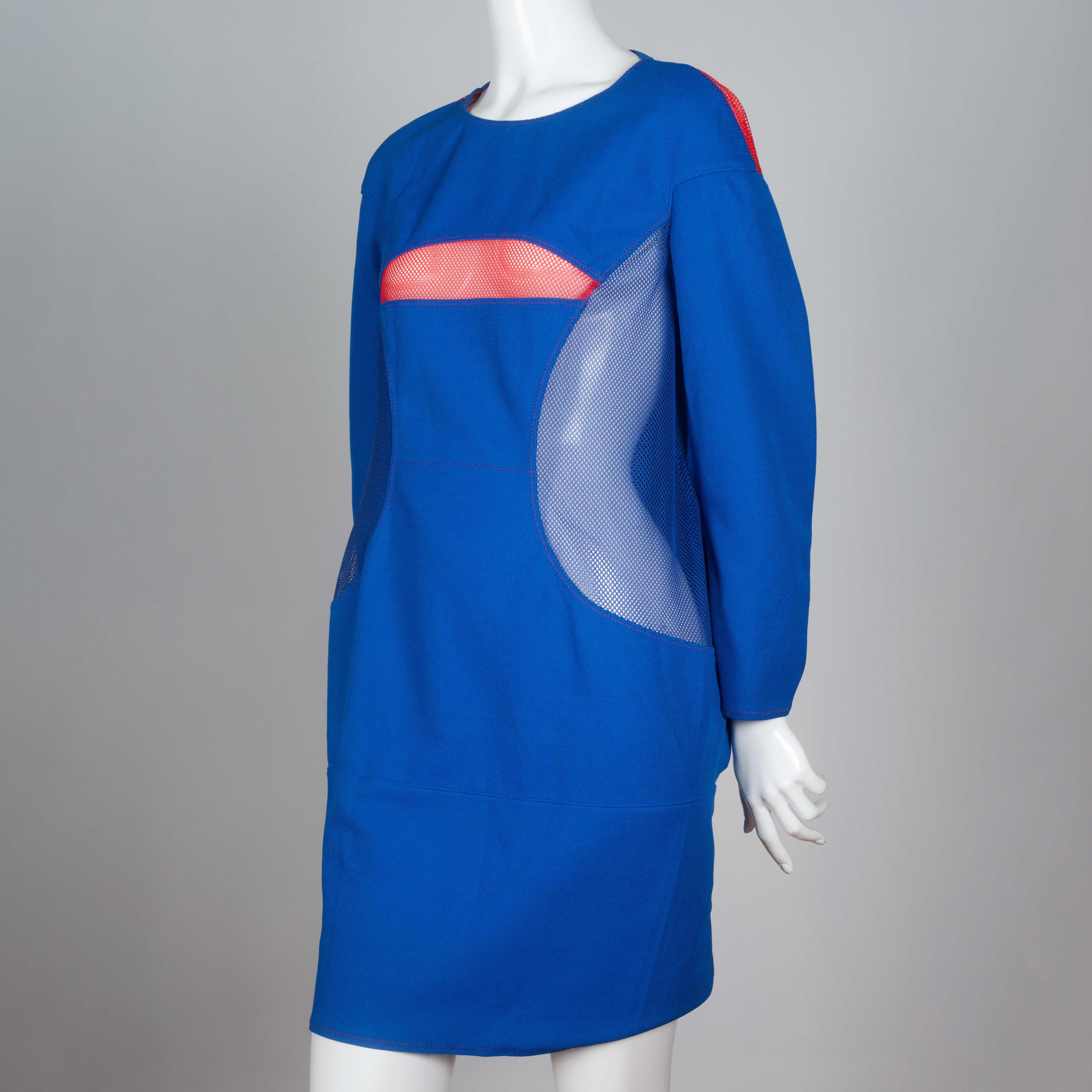 Junya Watanabe Comme des Garçons 2012 blue three quarter sleeve, knee length dress from Japan. Blue and pink mesh covered cut-outs and pink stitching completes the design. A sporty techno feel.
 
YEAR: 2012
MARKED SIZE: M
US WOMEN'S: M/L
US MEN'S: