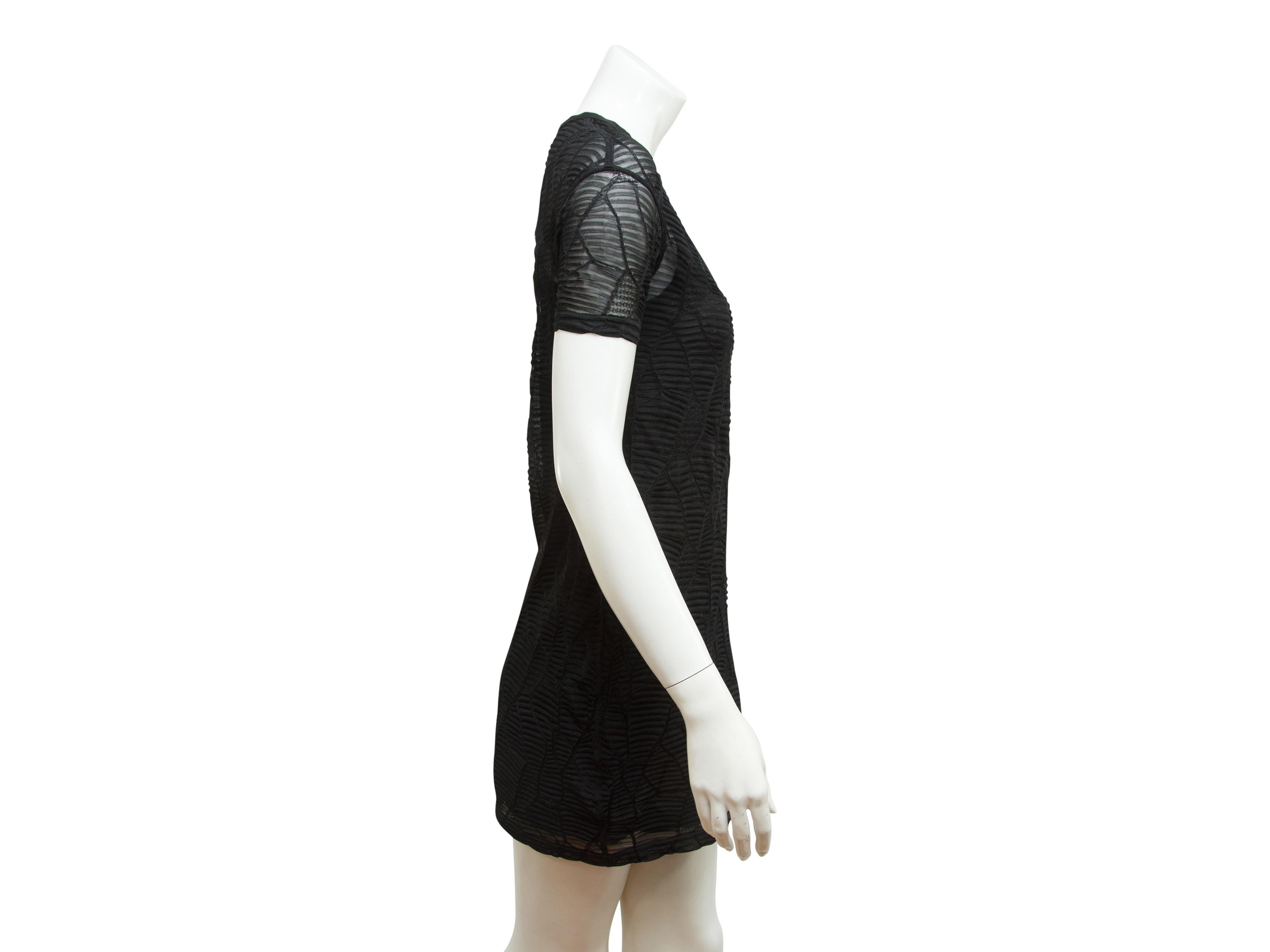 Product details:  Black textured tunic top by Junya Watanabe Comme des Garcon.  Crewneck.  Short sleeves.  Pullover style.  31