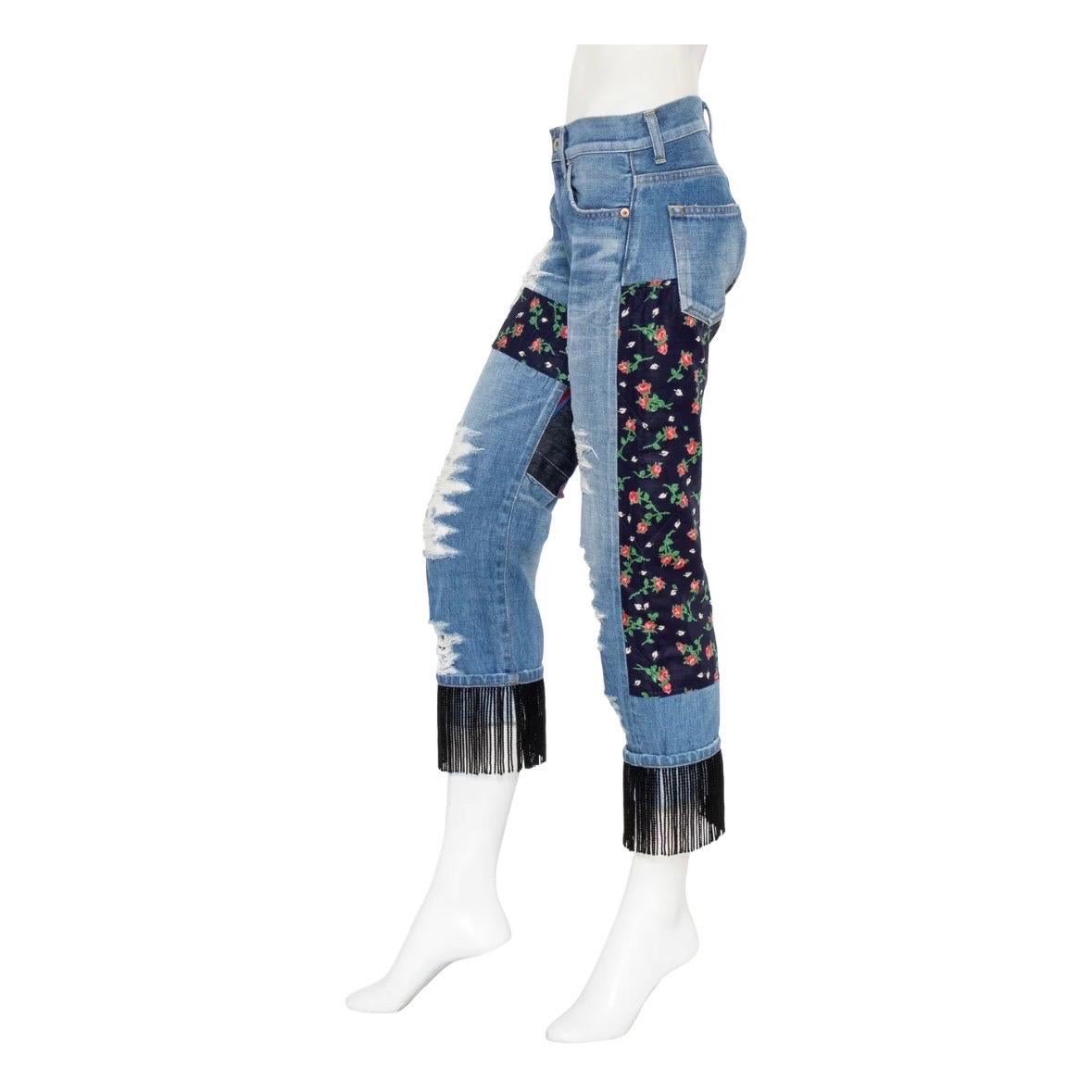 Fringed patchwork jeans by Junya Watanabe Comme des Garçon
2014 Collection
Ripped detailing
Patchwork with quilted florals and serape panels
Medium blue whiskered wash 
5-pocket construction
Low rise
Crop leg with fringe cuff
Materials: 100% cotton;