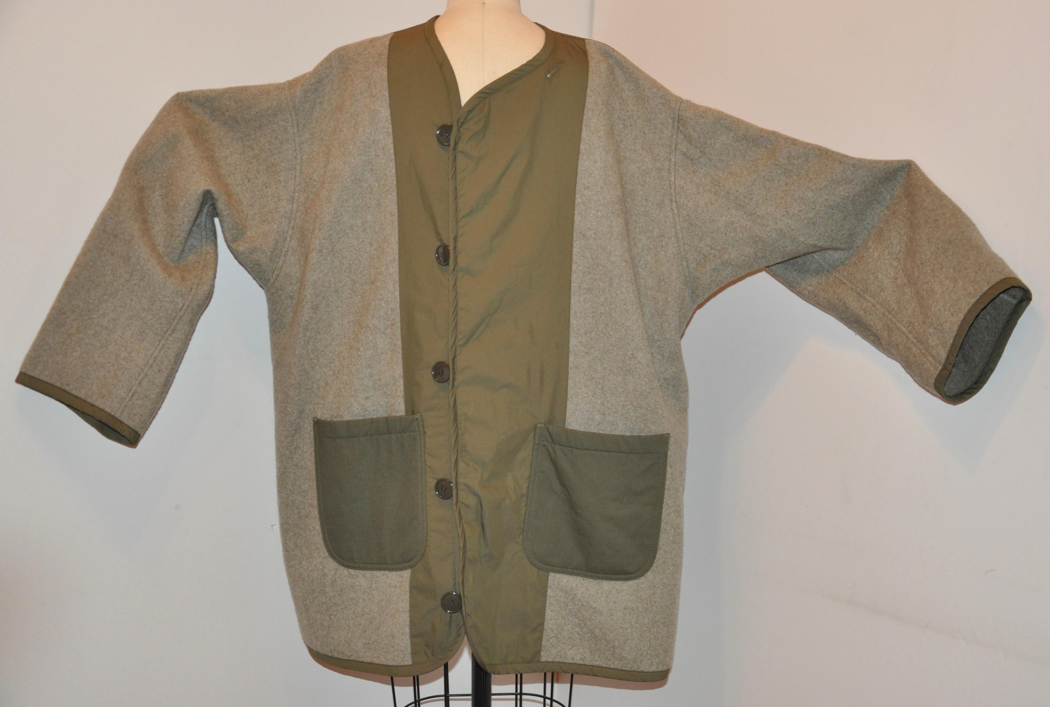 Junya Watanabe / Comme des Garcon oversized woollen detailed with khaki jacket features domain sleeves and dropped shoulders. The front has five buttons for closure and two huge patch pockets as well. Along the sleeves elbow are detailed gently