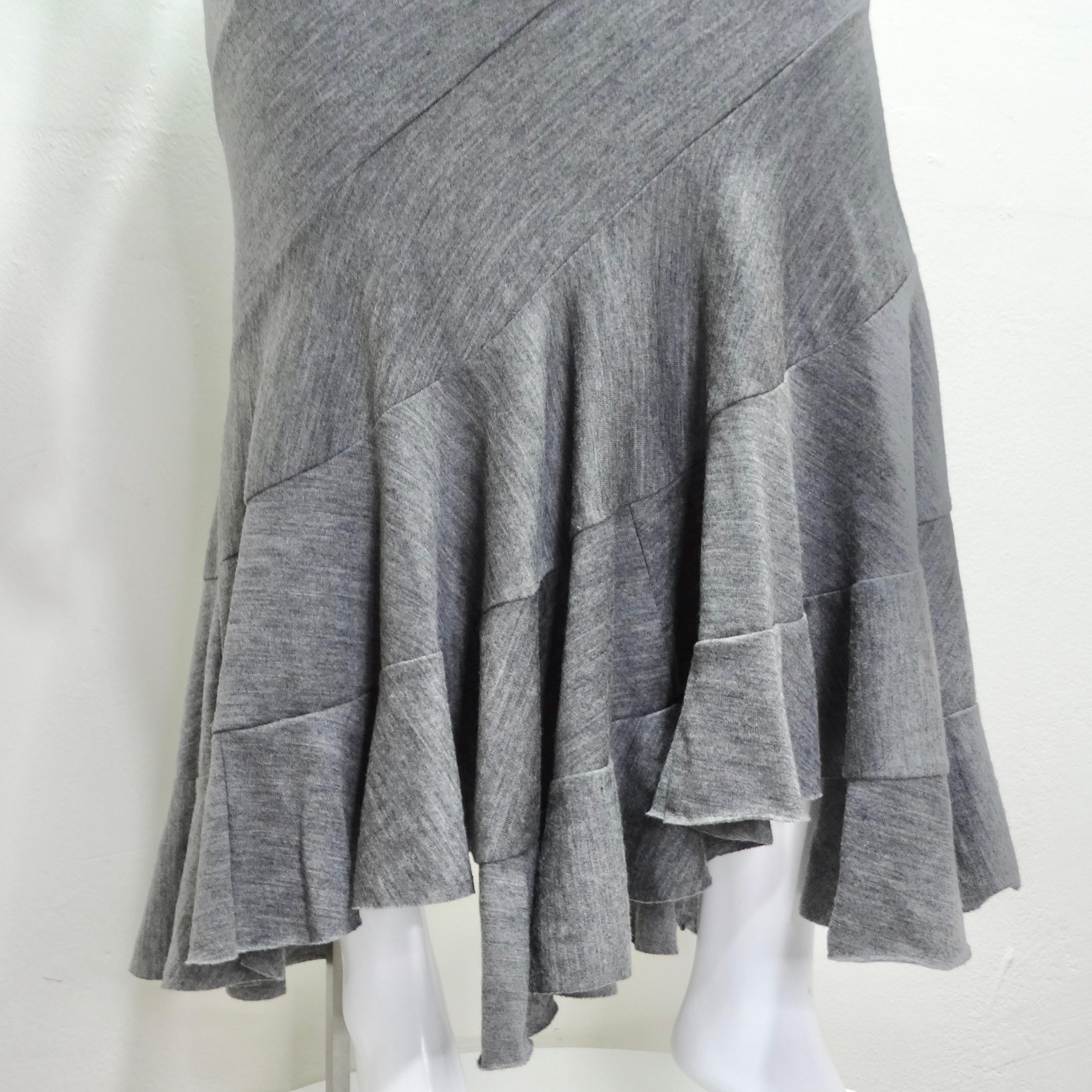 Introducing the Junya Watanabe Comme Des Garcons Grey Wool Tube Skirt/Dress – a masterful creation that seamlessly combines avant-garde design with versatility and comfort. This stretchy grey wool tube dress/skirt is a true fashion chameleon,