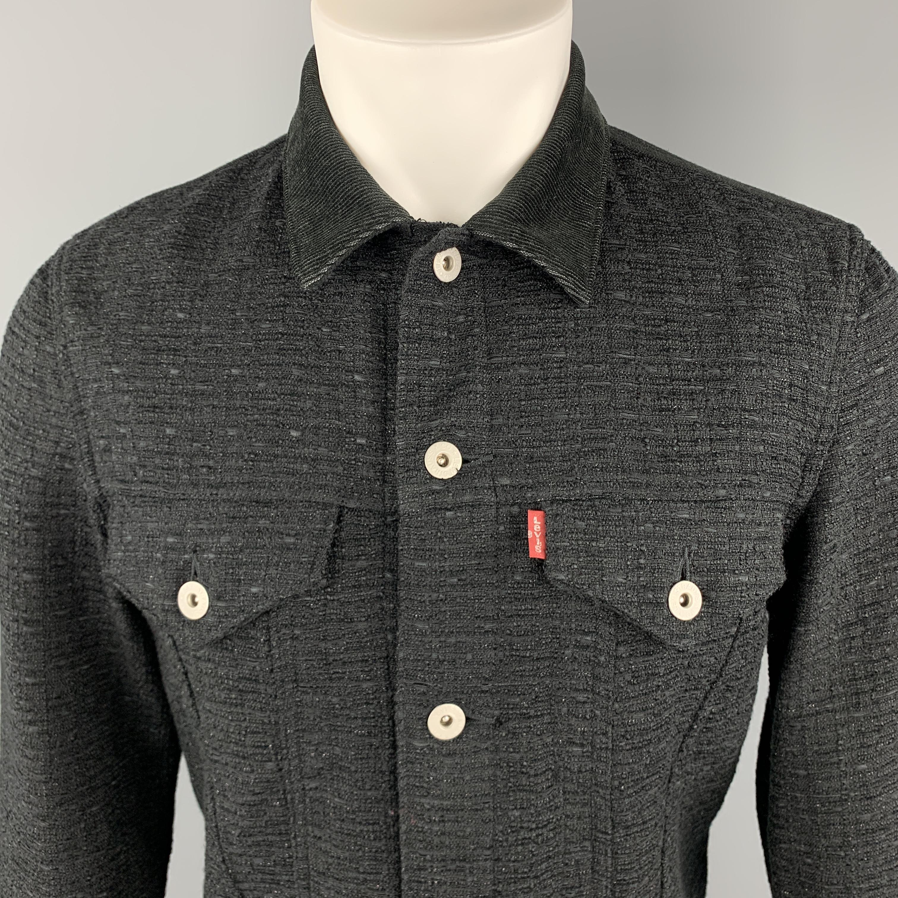 JUNYA WATANABE COMME des GARCONS MEN LEVI'S Trucker jacket comes in a black tone in a wool blend material, mixed fabrics, with a corduroy collar and cuffs, patch pockets, six buttons at closure, single breasted, elbow patches, and buttoned cuffs.