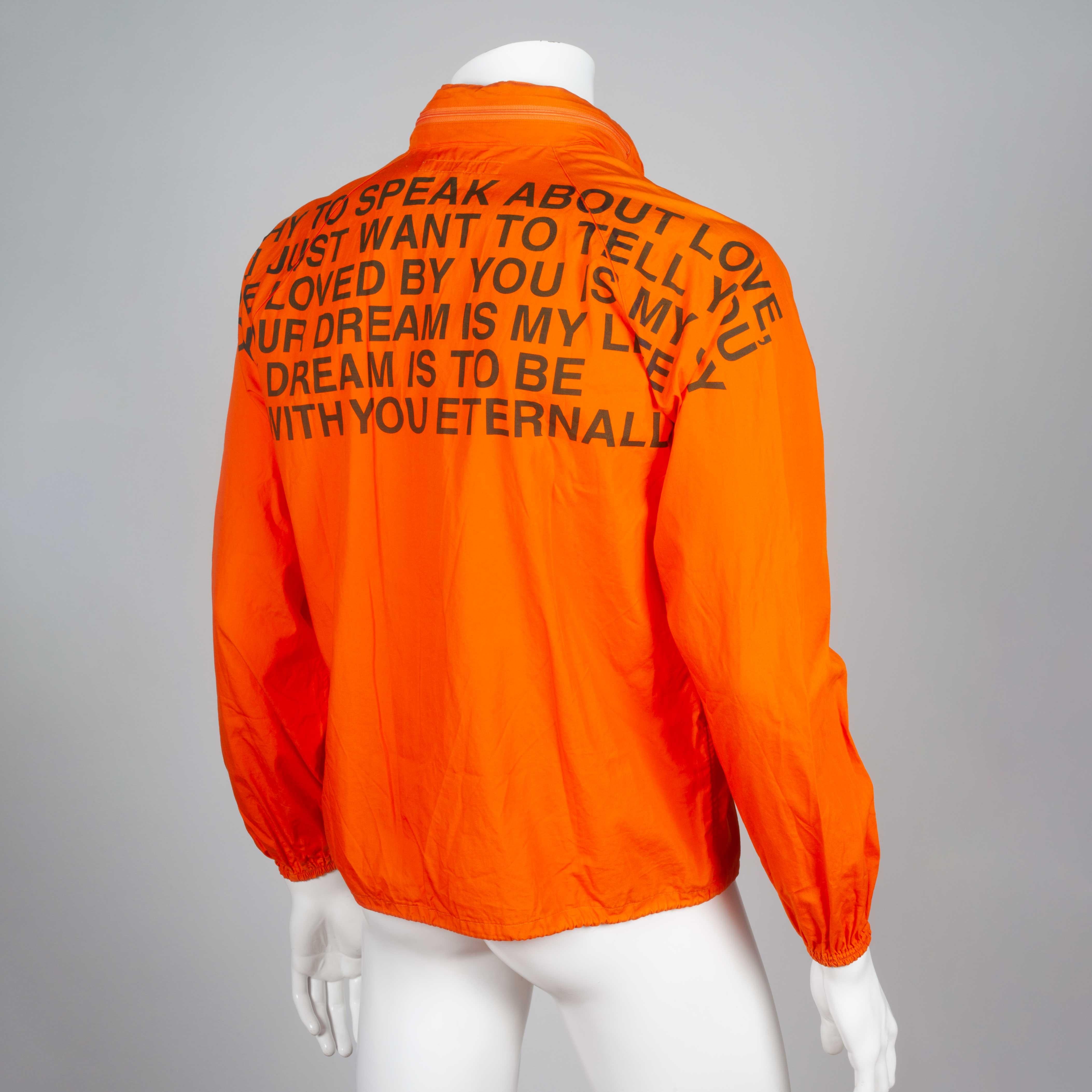 Junya Watanabe Comme des Garçons 2001 poem coat from Japan in bright orange. Poem on the back reads:

I'm shy to speak about love,
but I just want to tell you,
to love you is my joy
your dream is my life
my dream is to be with you eternally

The