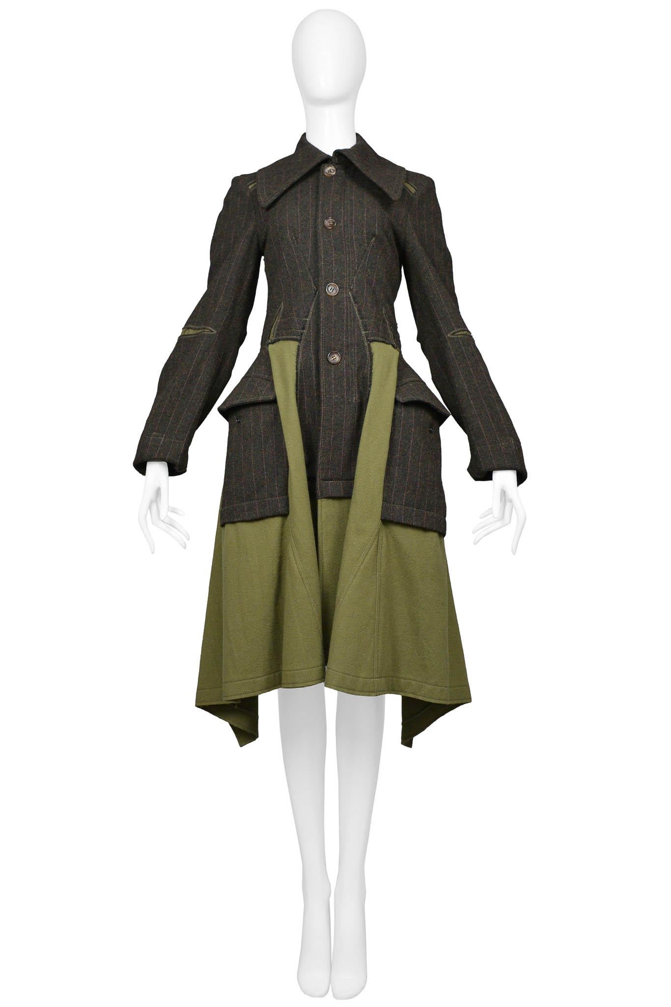 Resurrection Vintage is excited to offer a vintage Junya Watanabe wool coat featuring cargo insets, a high-to-low hem, a button front closure, and a pinstripe design.

Junya Watanabe
Size: Small
Exterior: Wool, Interior: Polyester, Cotton
Excellent