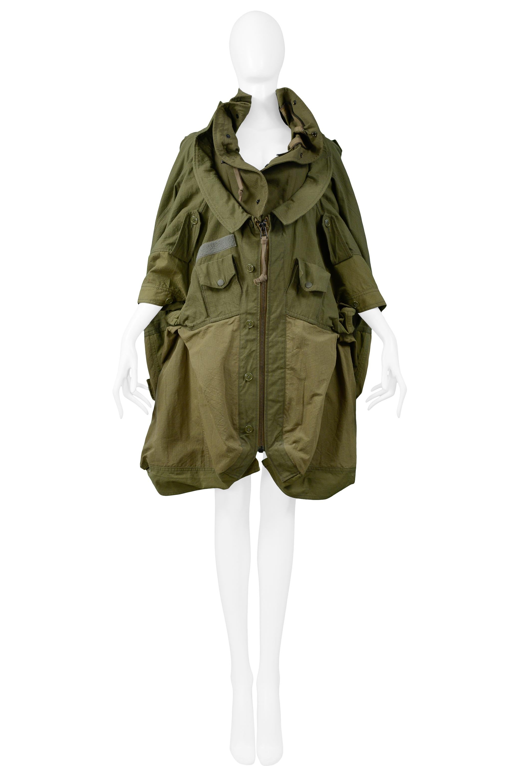 Resurrection Vintage is excited to offer a vintage Junya Watanabe army green deconstructed military-inspired jacket featuring a layered collar, oversized cuffed sleeves, multiple pockets, drawstring panels, and insets. From the Autumn/Winter 2006