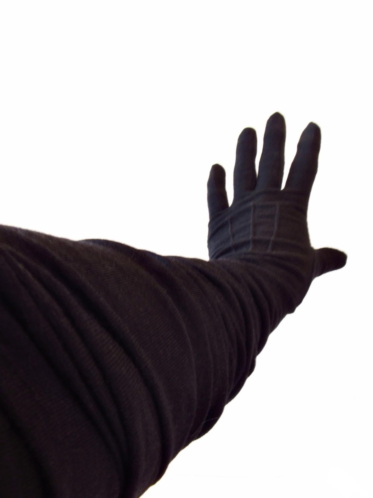These are elegant and warm black wool opera-style gloves from Junya Watanabe. They measure 30 inches from tip of fingers to end. 