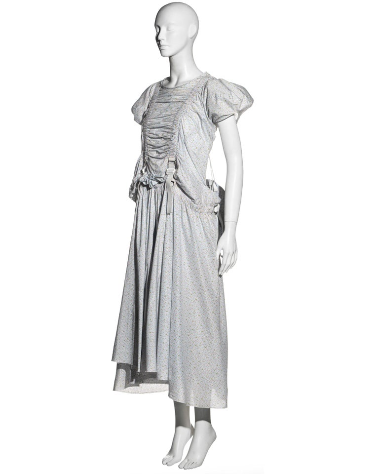 ▪ Junya Watanabe cotton dress 
▪ All-over floral pattern with pale blue background
▪ Puff sleeves 
▪ Adjustable white harness straps 
▪ Detachable backpack 
▪ Double layered skirt 
▪ Size Small
▪ Spring-Summer 2003