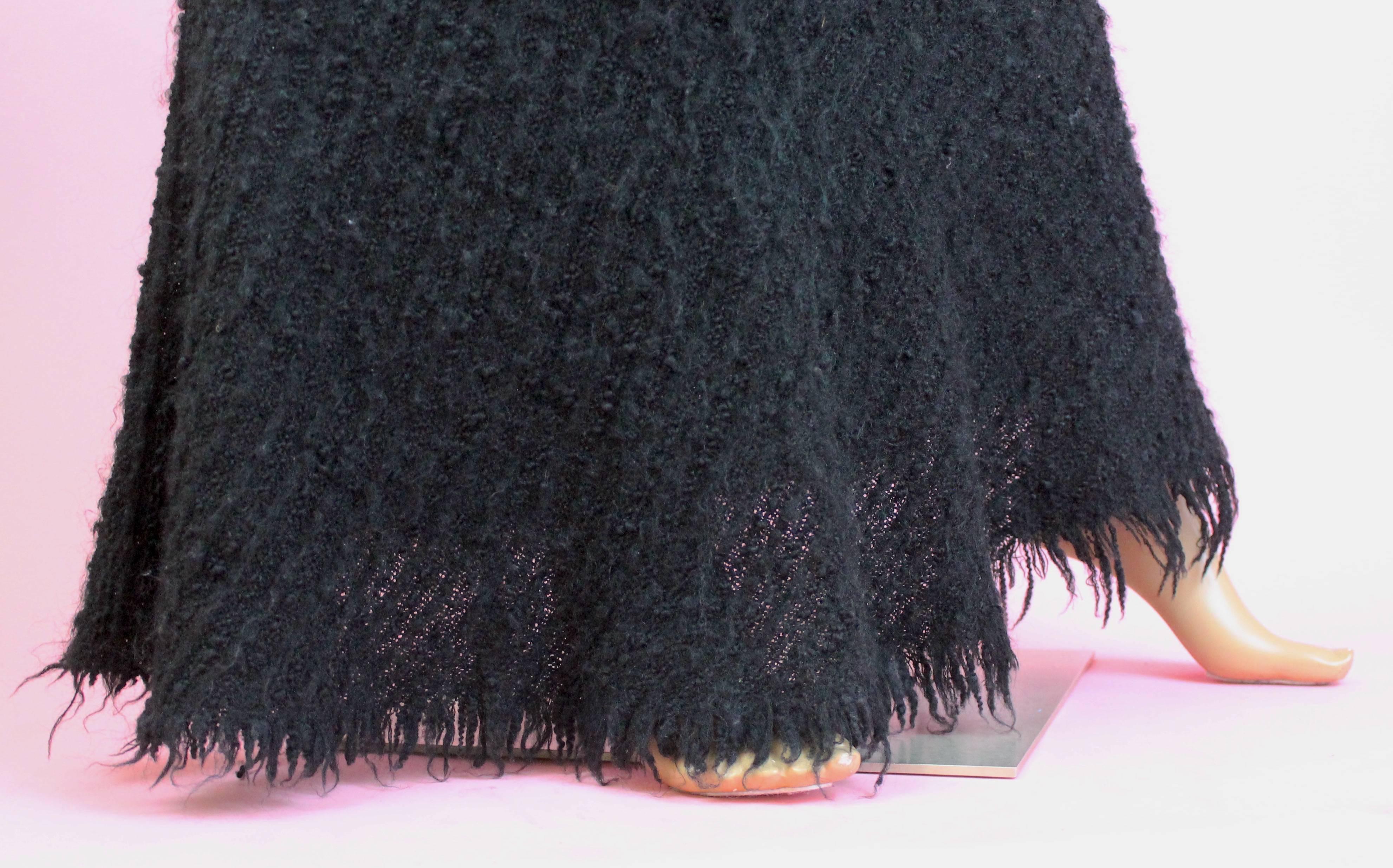 -Gorgeous black boucle skirt, fitted along the hips, flares near the ankles for mermaid effect
-Textured fabric is wool and mohair blend
-Zips in front
-Made in Japan 
-Sized S 

Approximate Measurements (in inches)
-Length:  42