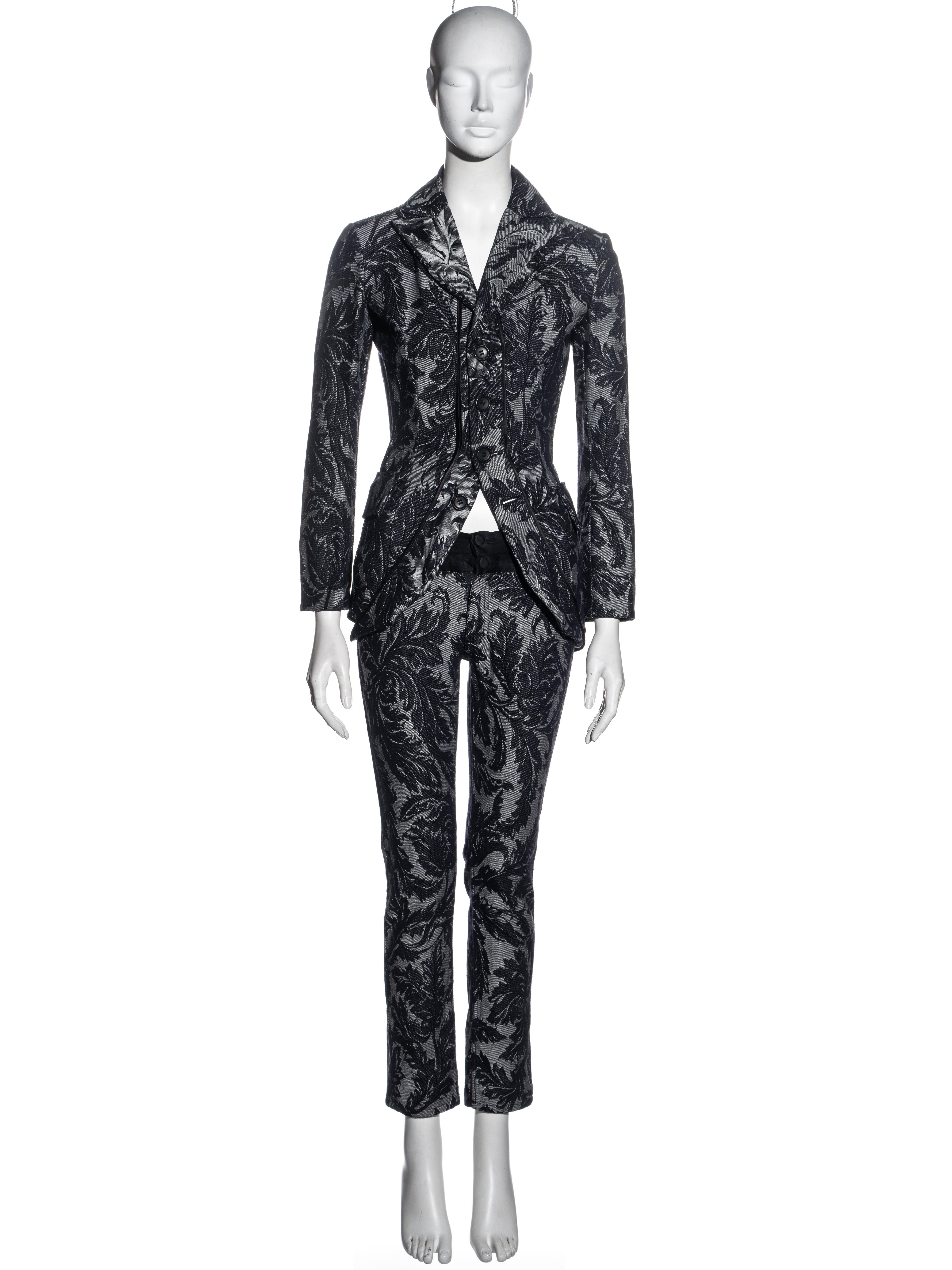 ▪ Junya Watanabe pant suit 
▪ Indigo denim brocade 
▪ Fitted tailcoat jacket 
▪ Matching skinny pants with cummerbund-style waistband
▪ Size: Extra Small 
▪ Spring-Summer 2007
▪ 100% Cotton
▪ Made in Japan