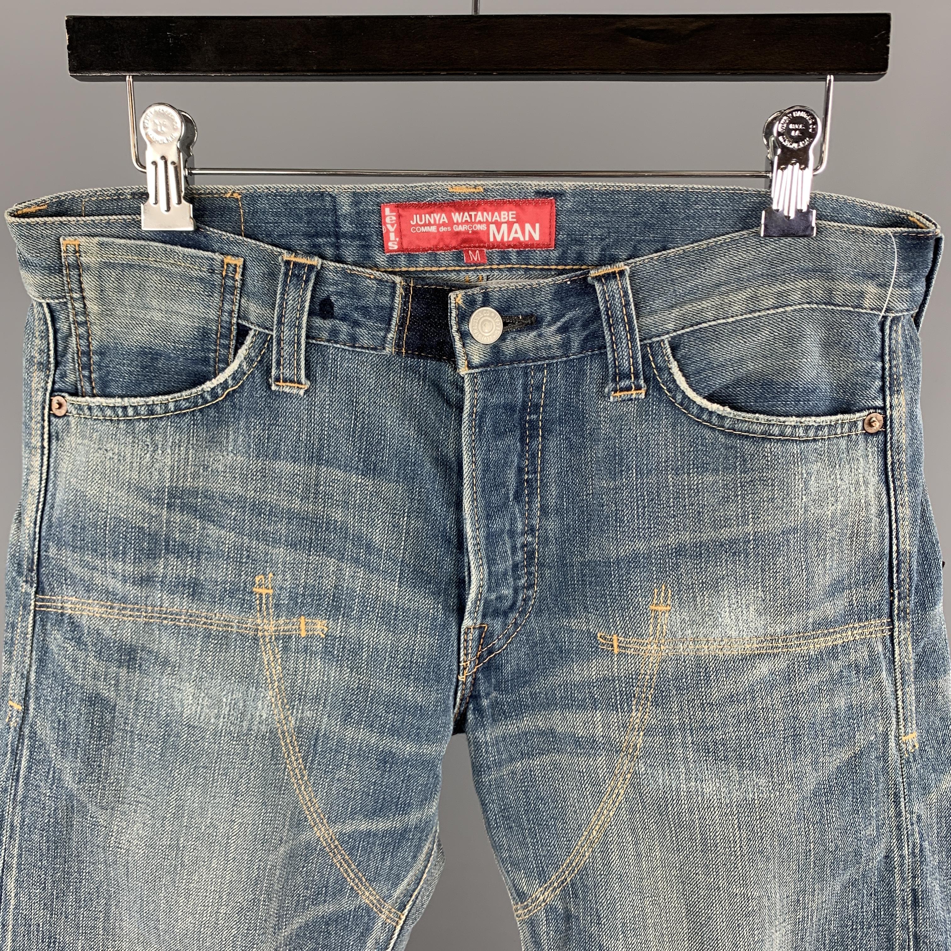 JUNYA WATANABE COMME des GARCONS MAN x LEVI'S jeans comes in a light blue washed selvedge denim featuring stitching details, camouflage trim liner, and a button fly closure. AD2010. Made in Japan.
 

Excellent Pre-Owned Condition.
Marked: