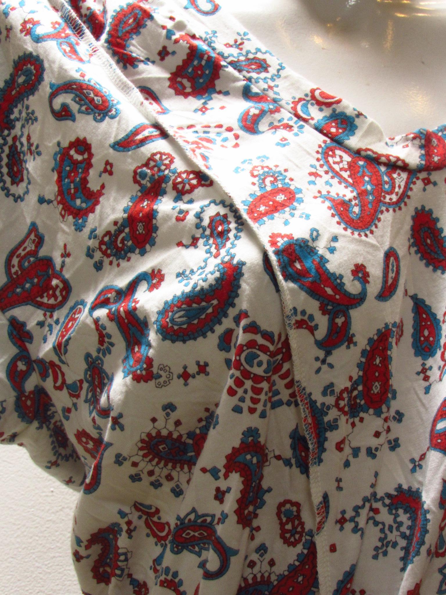 A paisley print on this white sweet short sleeve top of comfortable cotton jersey is distinctly different with a faux-wrap front and asymmetric scrunched gathering in back by vintage Junya Watanabe.
