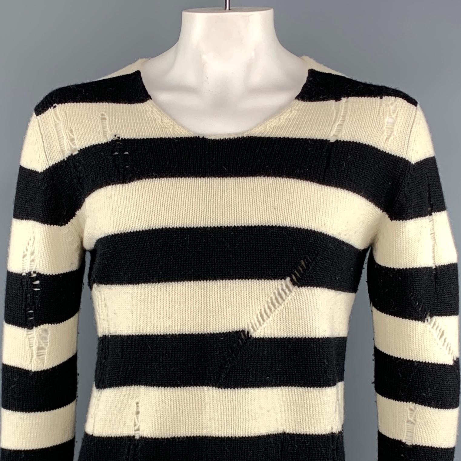 JUNYA WATANABE sweater comes in black and white stripe wool featuring distressed details throughout and a round neck. AD2014. Made in Japan.
 
Excellent Pre-Owned Condition.
Marked: L
 
Measurements:
 
Shoulder: 19.5 in.
Chest: 44 in.
Sleeve: 28