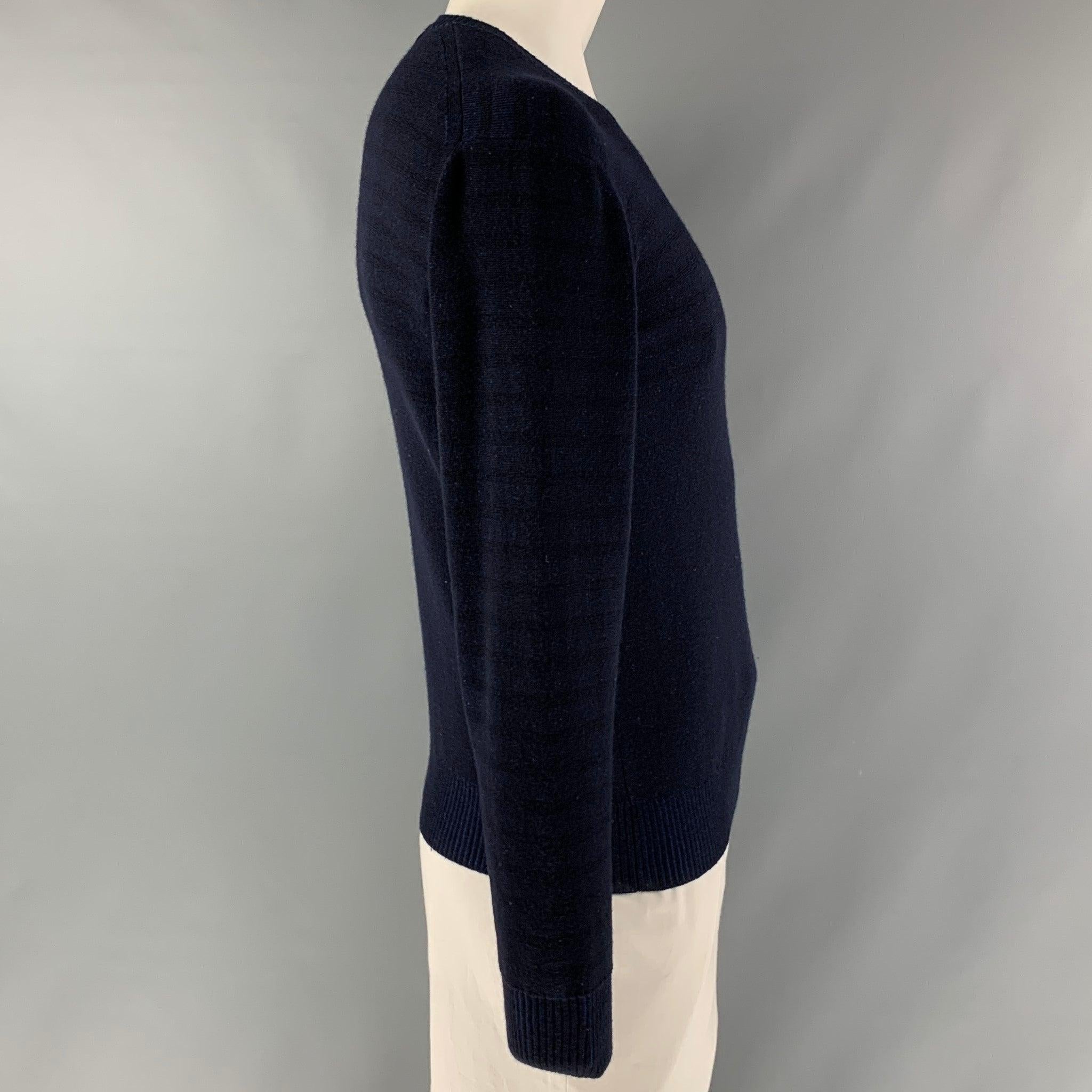 JUNYA WATANABE long sleeve pullover comes in a navy and black stripped wool blend jersey fabric featuring v-neck. Made in Japan.Very Good Pre-Owned Condition. Minor signs of wear. 
 

 Marked:  L 
 

 Measurements: 
  
 Shoulder: 23 inches Chest: 48