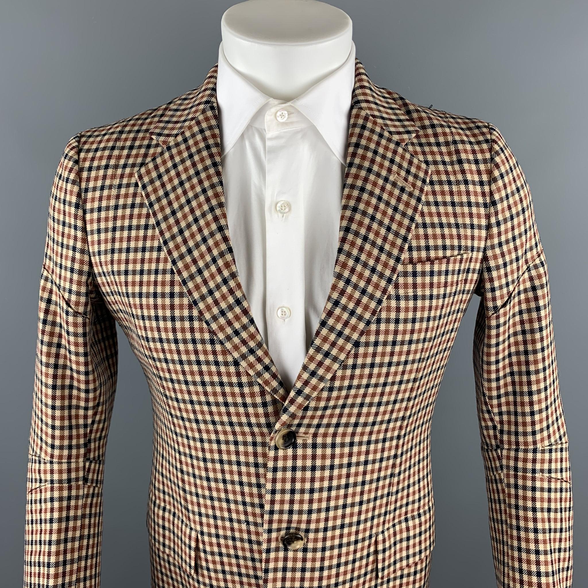 JUNYA WATANABE sport coat comes in a tan plaid wool with a half red liner featuring a notch lapel, flap pockets, cutout details, single vent, and a two button closure. Made in Japan.

Excellent Pre-Owned Condition.
Marked: JP L /
