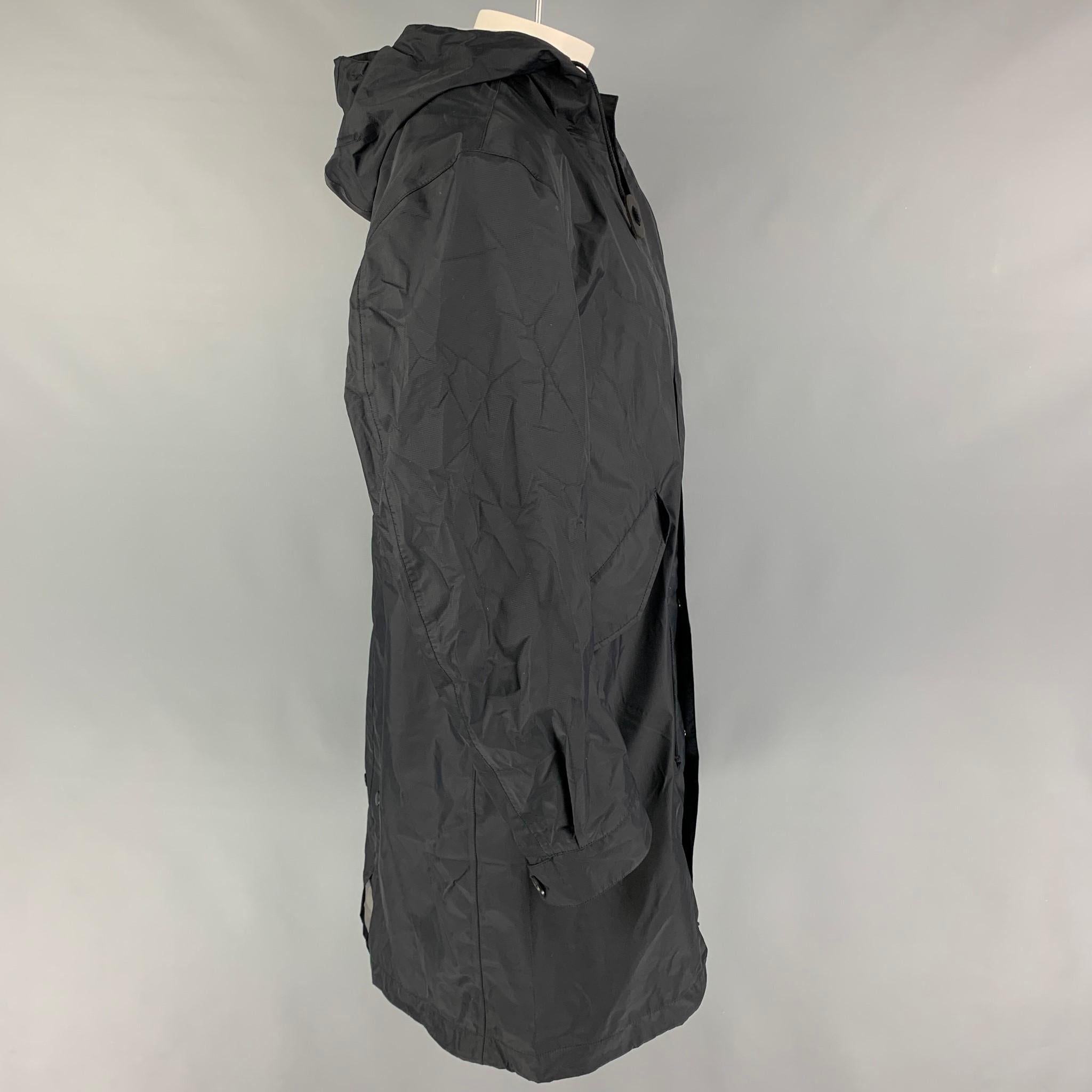 JUNYA WATANABE eYe coat comes in a black nylon with GORE-TEX technology featuring a hooded style, flap pockets, leather trim, and a hidden zip & snap button closure. 

Very Good Pre-Owned Condition.
Marked: M / AD2016

Measurements:

Shoulder: 21