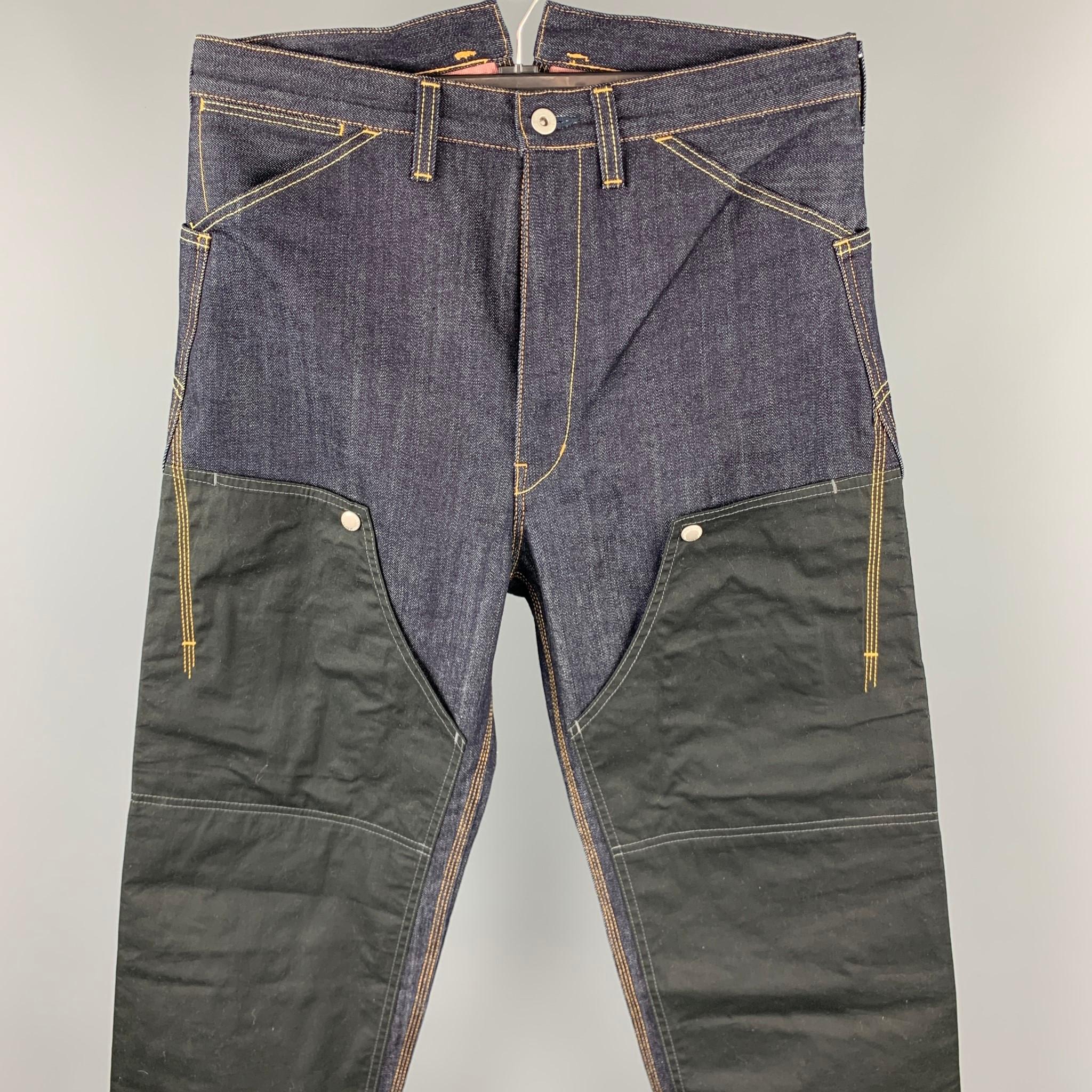 JUNYA WATANABE jeans comes in a indigo denim featuring mixed material patchwork designs featuring front pockets, snap button details, contrast stitching, and a zip fly closure. Made in Japan. 

Excellent Pre-Owned Condition.
Marked: M /